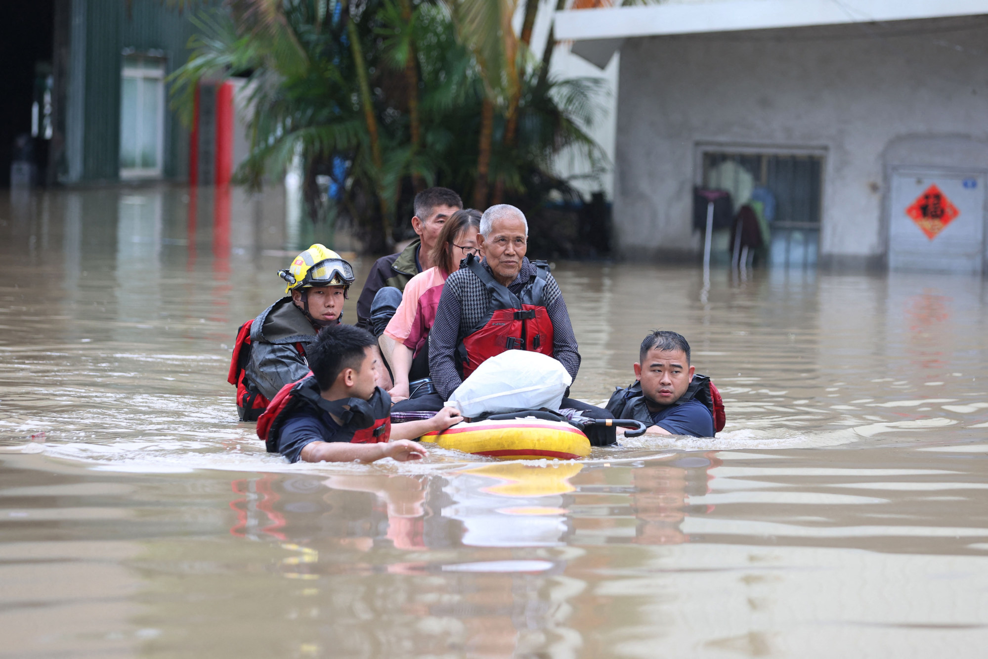 Rescuers evacuating residents in a flooded area after heavy rains in eastern China’s Fujian province. Photo: AFP