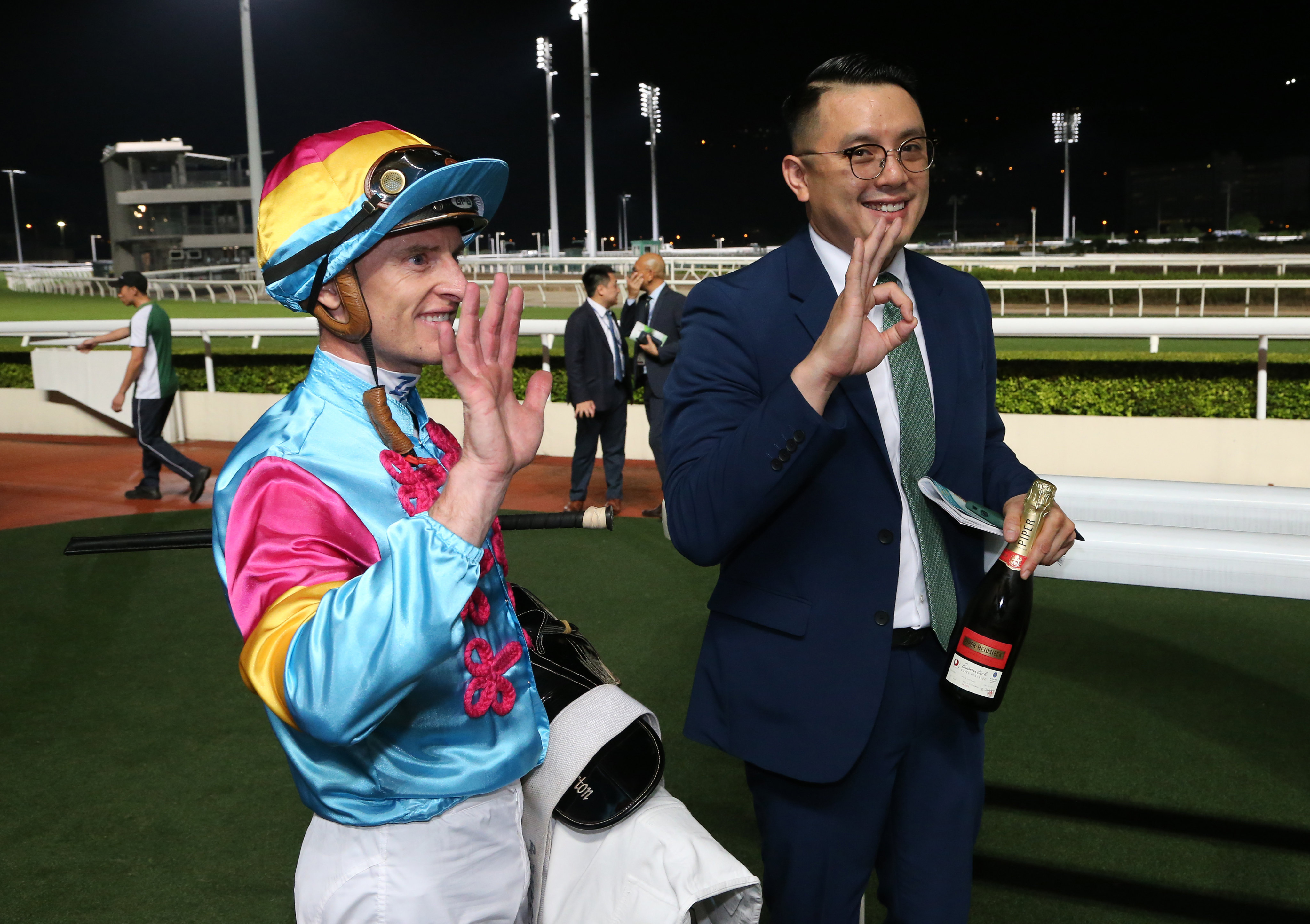 Trainer Pierre Ng celebrates his maiden treble at Sha Tin on Sunday, while Zac Purton soaks up a five-timer. Photos: Kenneth Chan