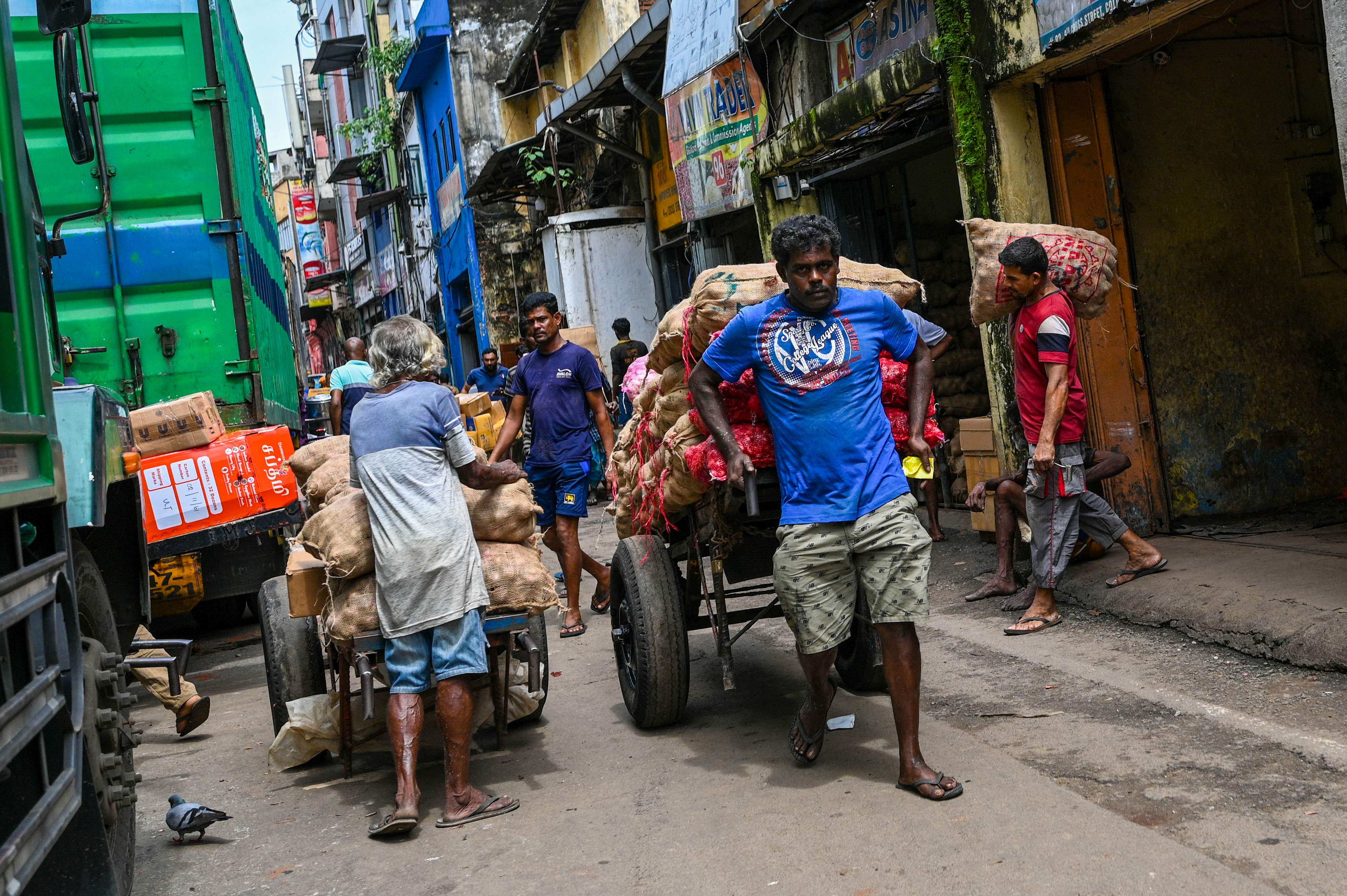 A labourer pulls a cart at a wholesale market in Colombo. Photo: AFP