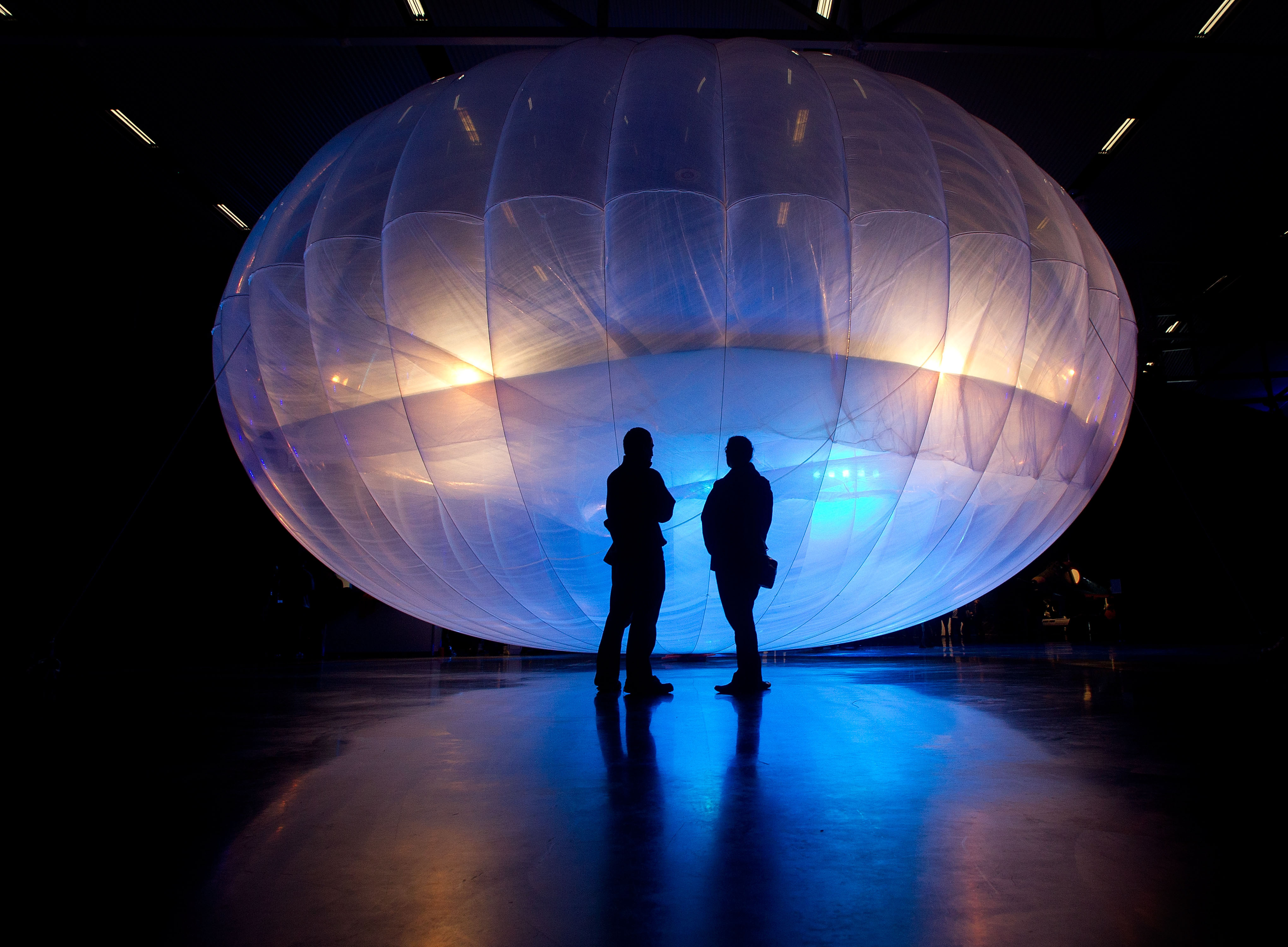 Visitors stand next to a high-altitude balloon, part of an earlier Google project to deliver internet to remote places, on display in 2013. Photo: AFP
