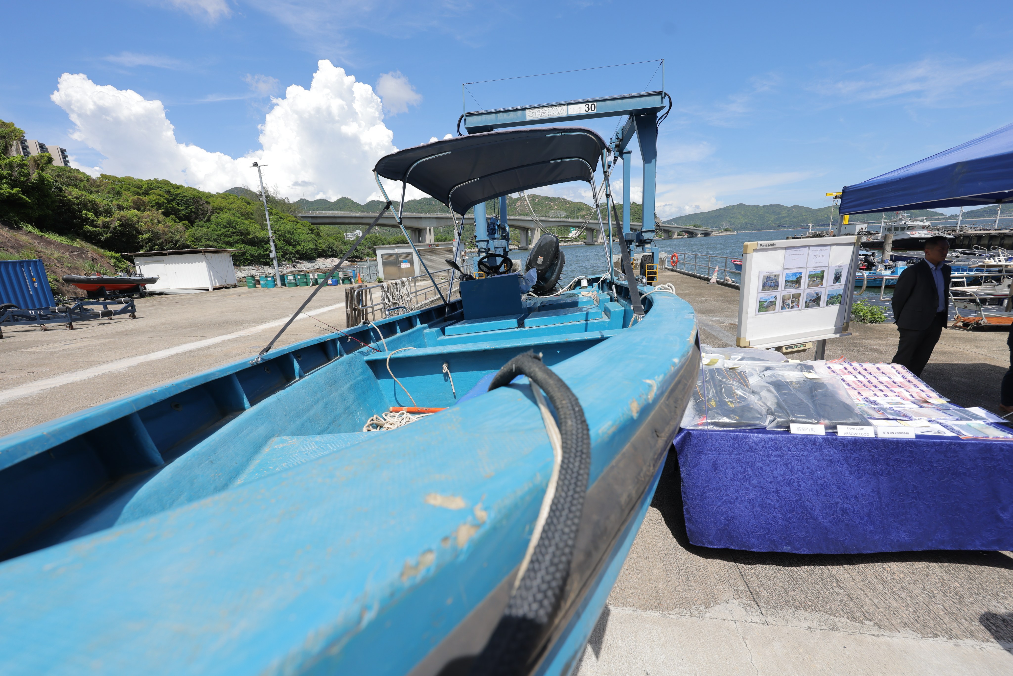 Police show a speedboat, money and other items seized in a dawn raid on an alleged people-smuggling operation. Photo: Jelly Tse