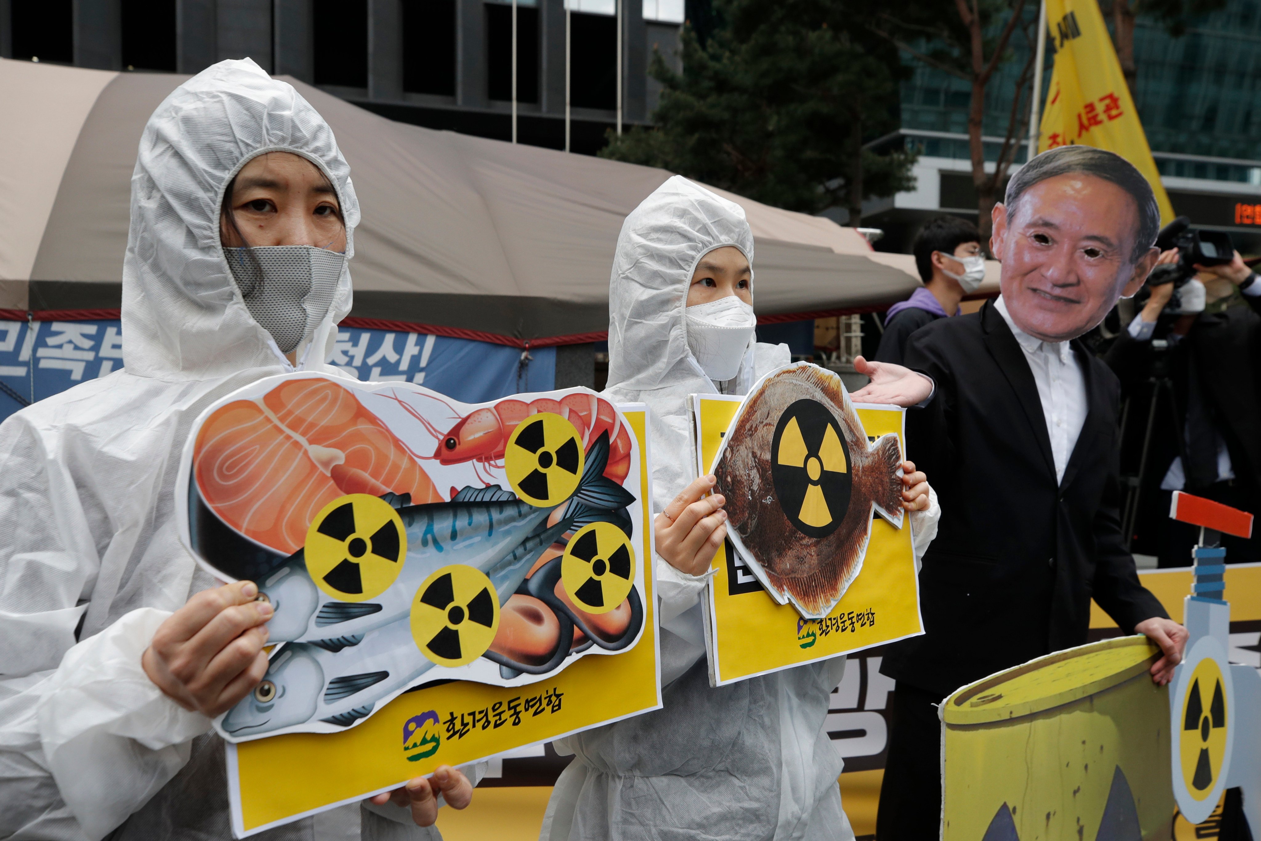 Environmental activists denounce the Japanese government’s plan to start releasing treated radioactive water from the wrecked Fukushima nuclear plant into the Pacific Ocean. Photo: AP