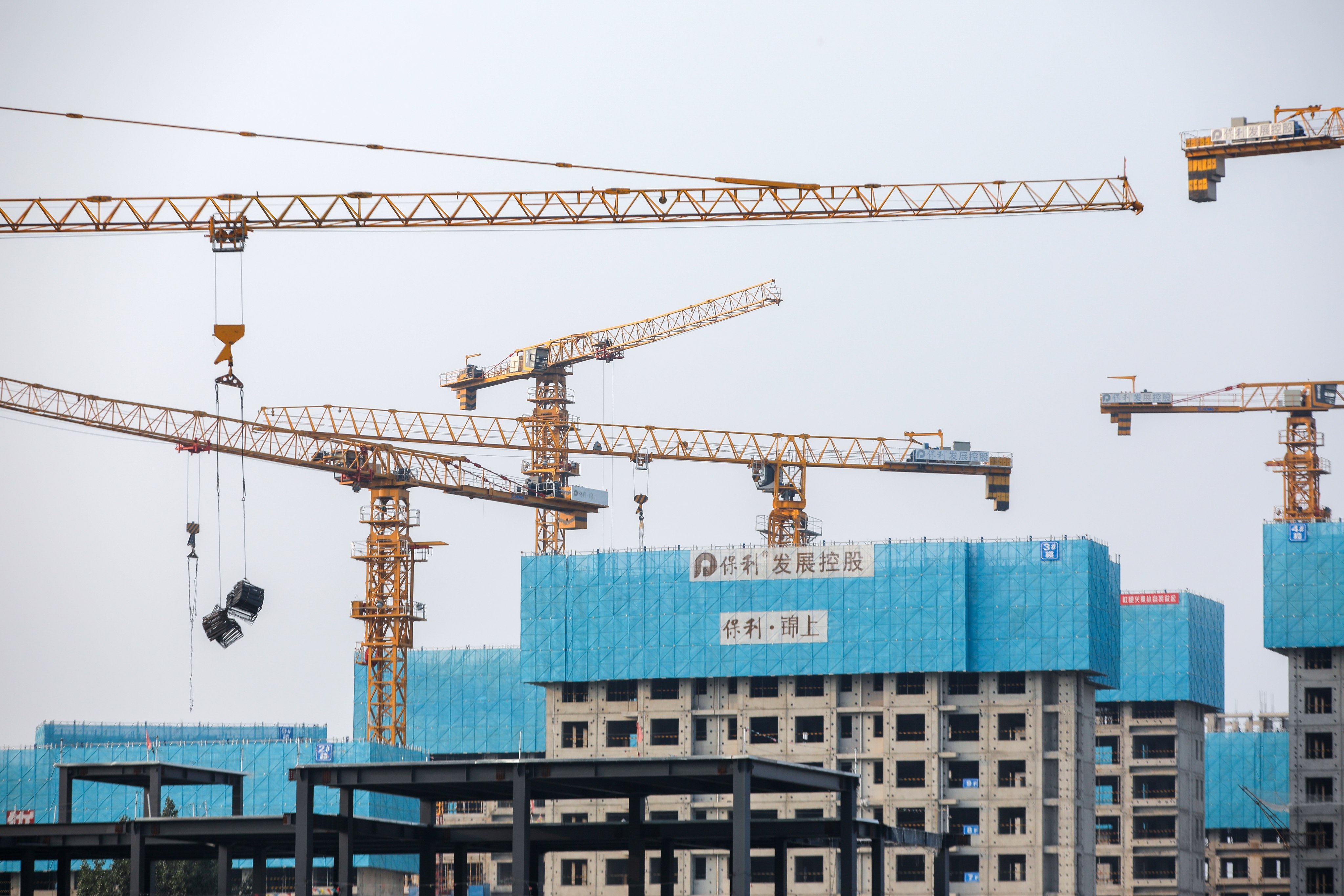 Buildings under construction in Beijing. Currently, 23 A-share developers have revealed share sale plans for raising more than 92.5 billion yuan, but only a few have been given approvals so far, according to Guosheng Securities. Photo: EPA-EFE
