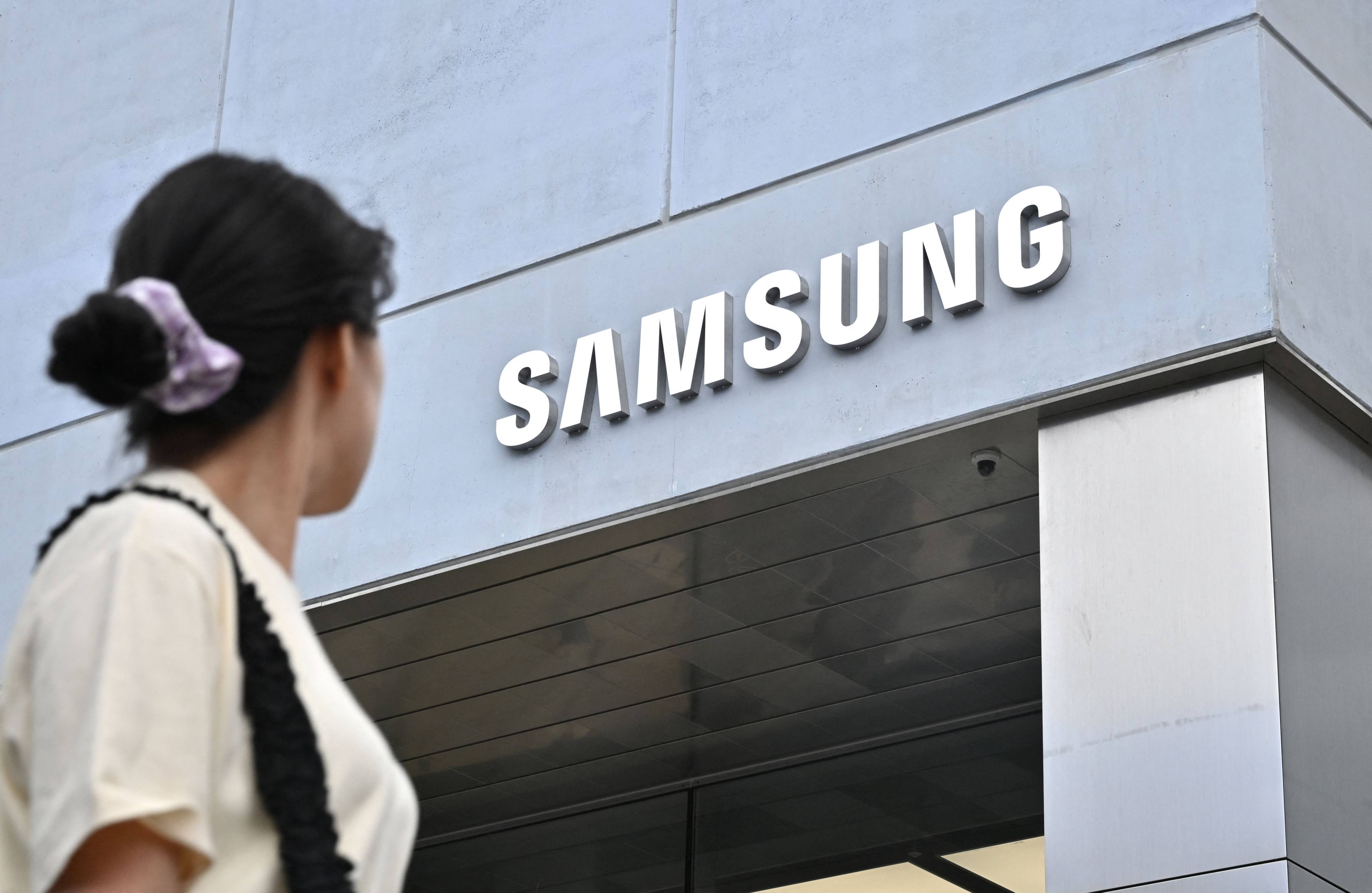 A woman walks past a new flagship store of Samsung Electronics in Seoul, South Korea, on June 28, 2023. Photo: AFP