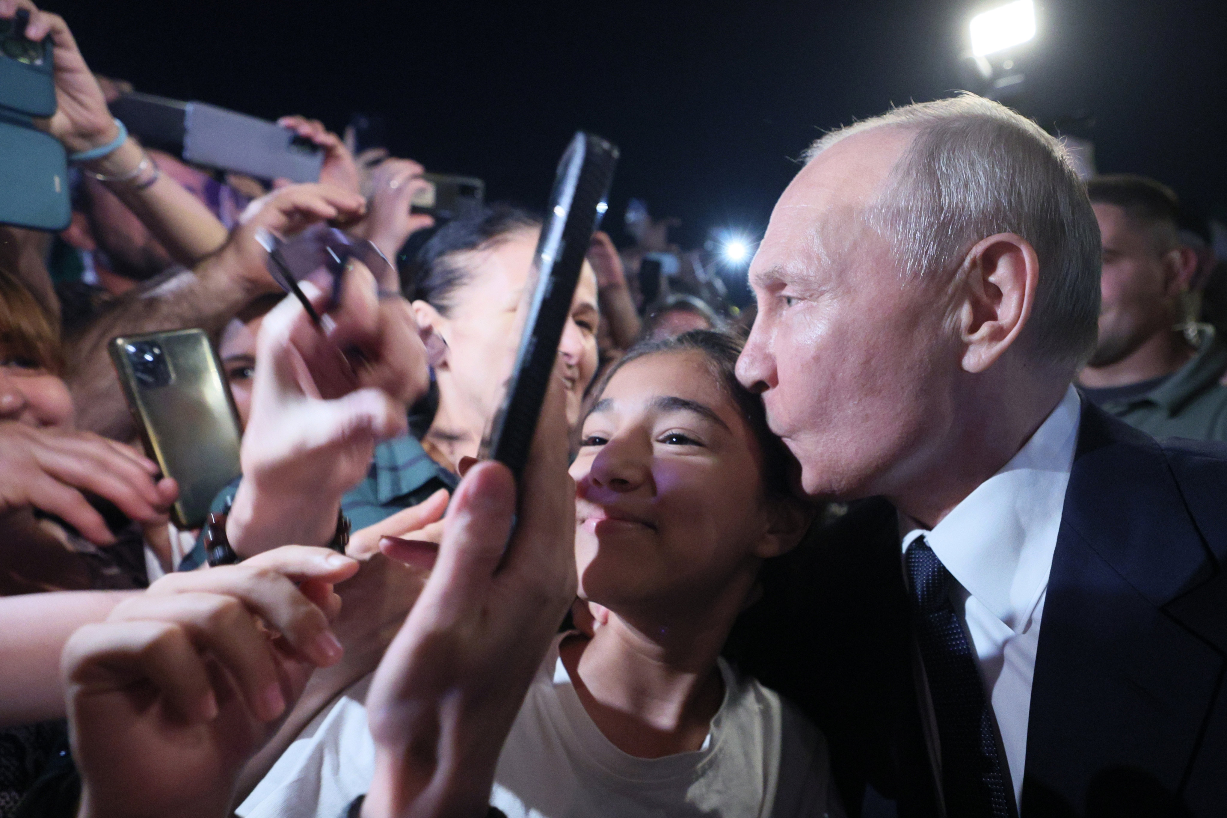 Russian President Vladimir Putin kisses a girl on the head on Wednesday. It contrasted sharply with a strict Covid-19 quarantine regime the Kremlin long maintained for anyone due to meet the 70-year-old leader, to avoid possible infection. Photo: via AP