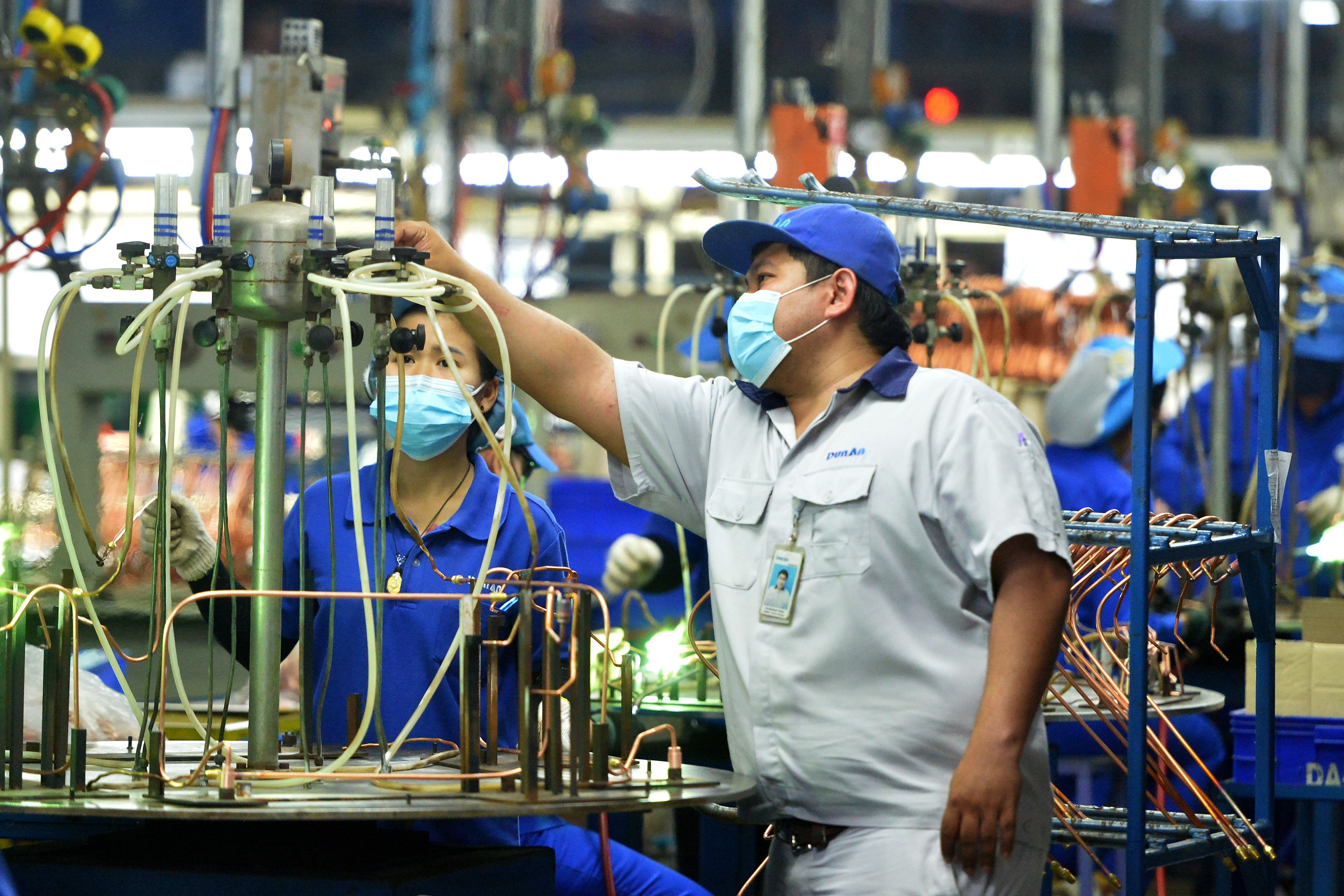 People work on a production line at a metals factory in Thailand. Photo: Xinhua