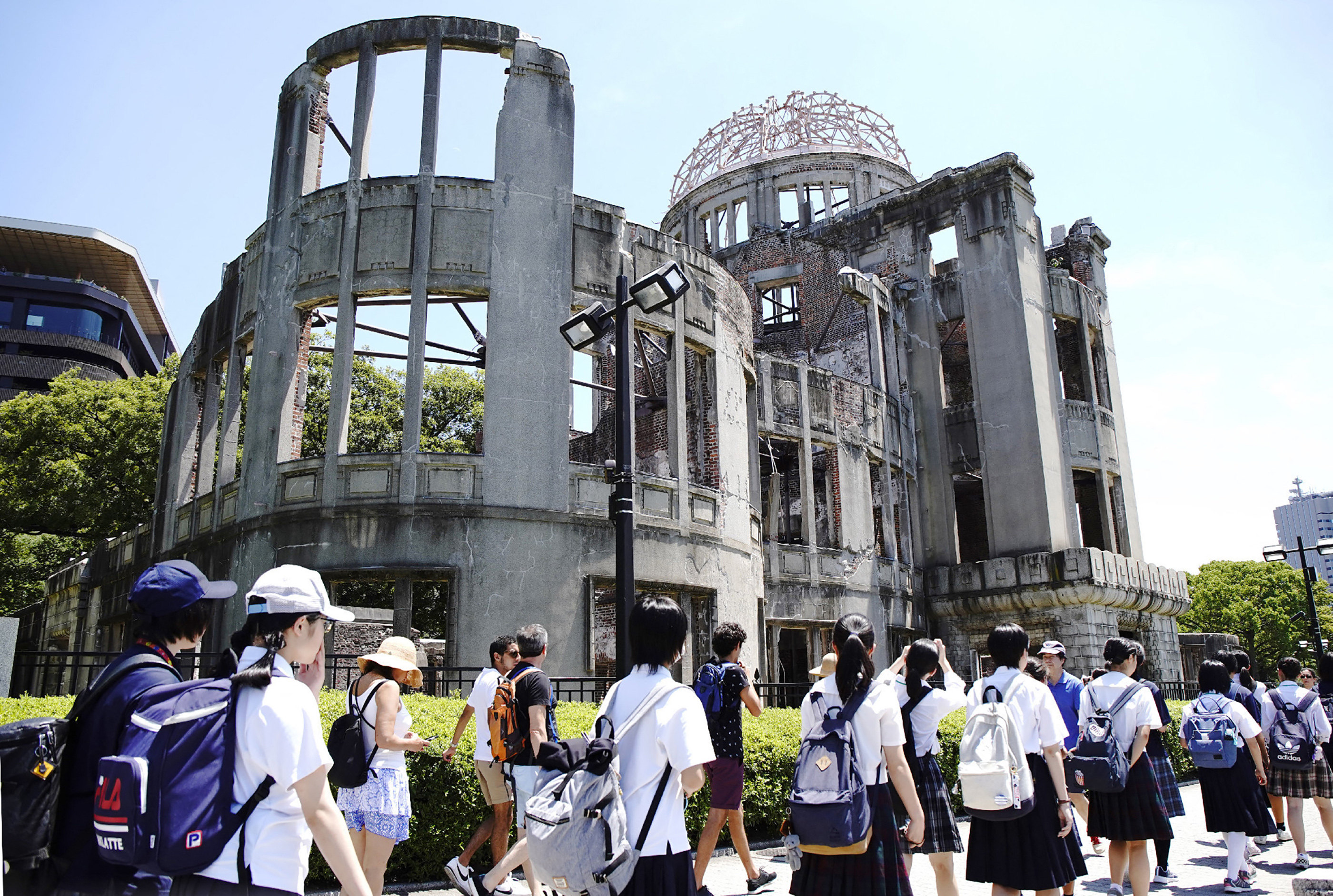 Students walk past the Atomic bomb dome at the Peace Memorial Park in Hiroshima in August 2019. Photo: AFP