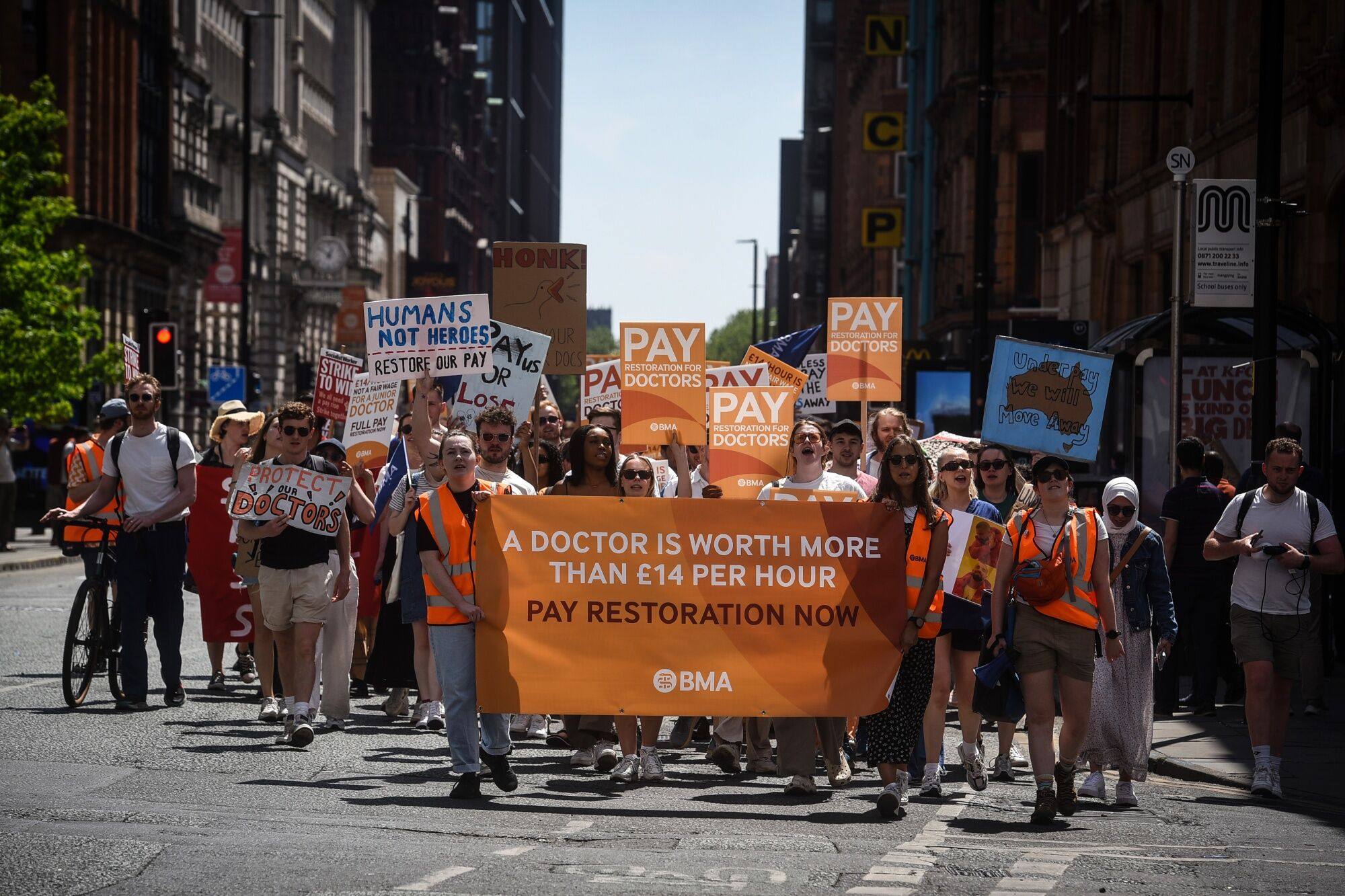 Junior doctors march towards the venue of the NHS ConfedExpo during the second day of strike action on June 15. Photo: Bloomberg