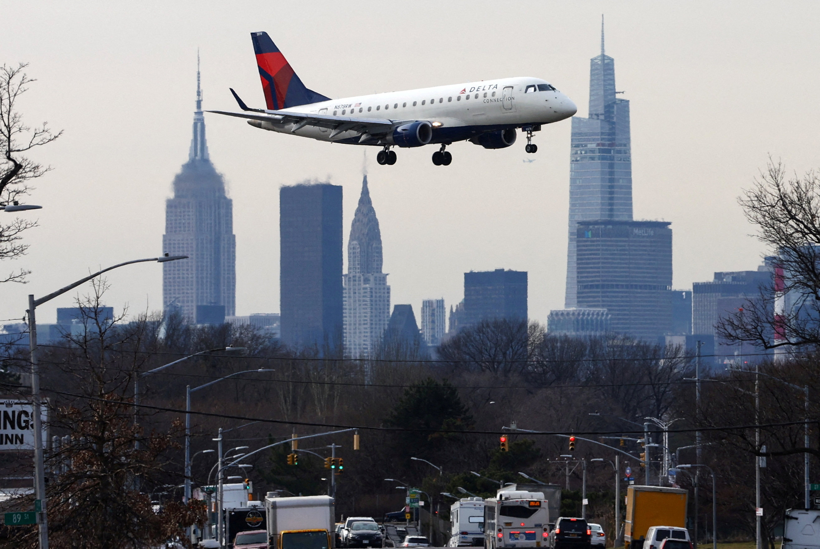 A Delta Airlines jet comes in for a landing in front of the Empire State Building and Manhattan skyline at Laguardia Airport, in New York City, New York. Photo: Reuters