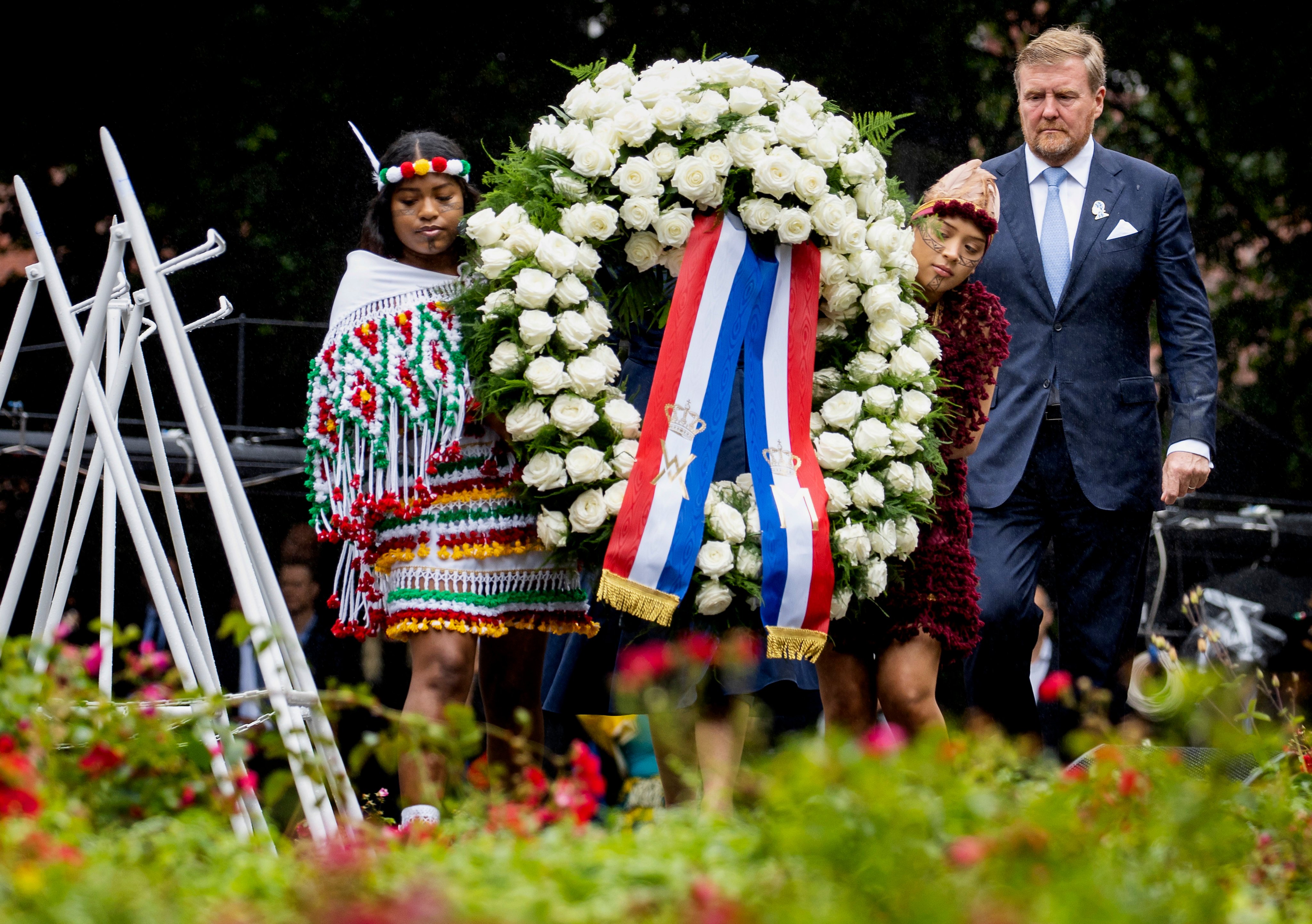 Dutch King Willem-Alexander lays a wreath at the slavery monument after apologising for the royal house’s role in slavery, in Amsterdam, Netherlands on Saturday. Photo: Pool Photo via AP