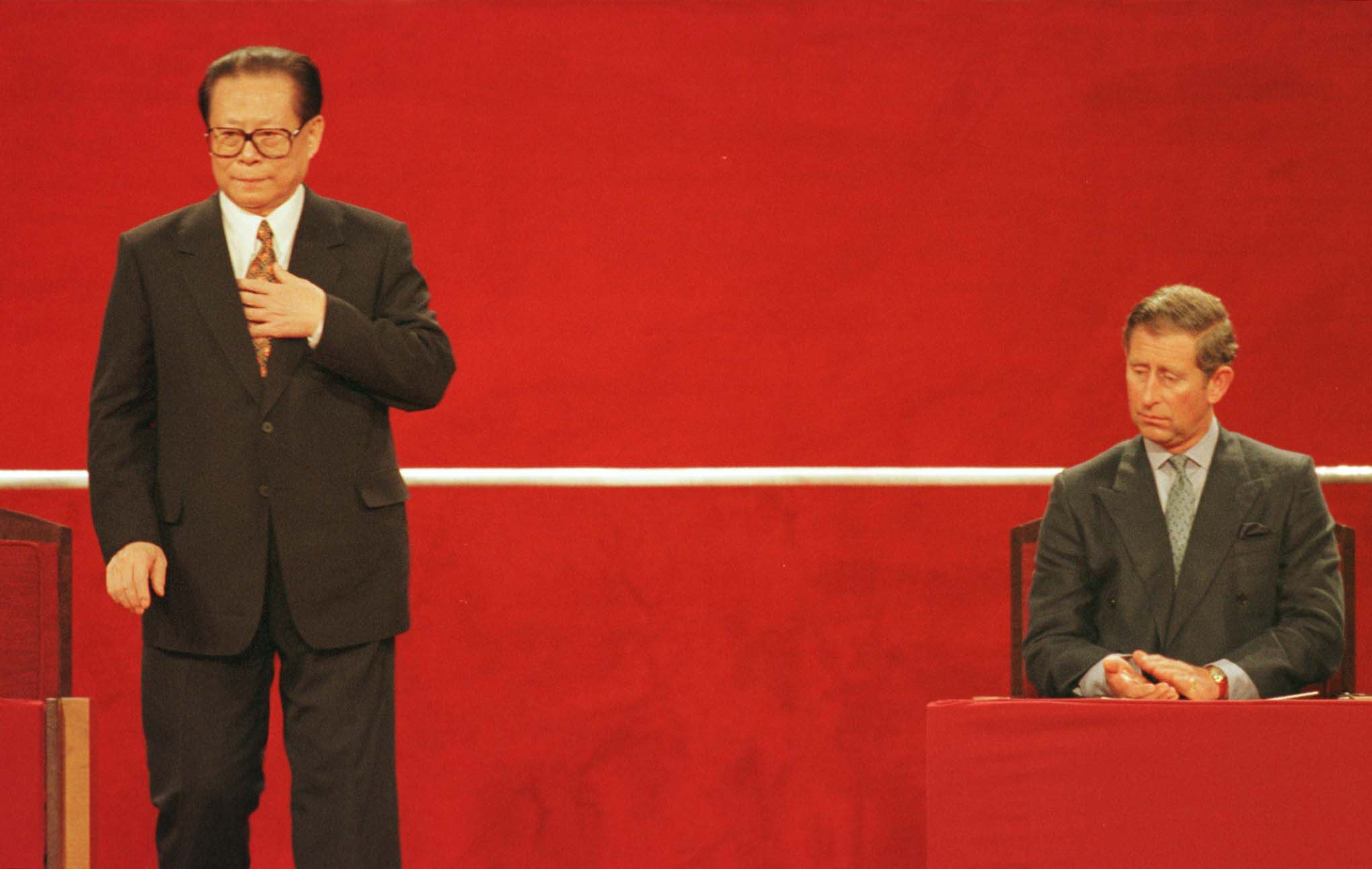 Chinese President Jiang Zemin (left) rises to speak at the Hong Kong Convention Center following the handover of Hong Kong to China on July 1, 1997, as Britain’s then-prince of Wales, Charles Windsor, applauds. Photo: AFP/pool