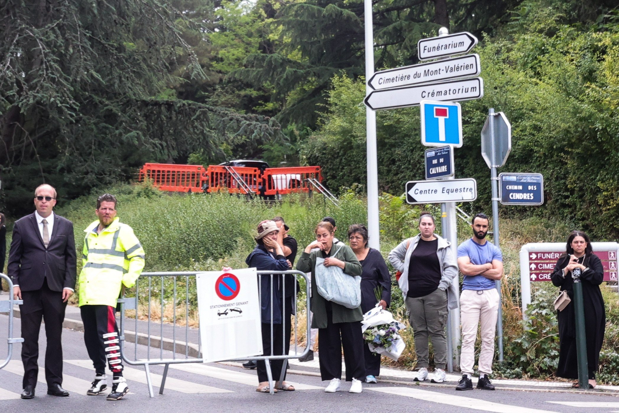 People wait next to the entrance of Mont Valerien cemetery ahead of the funeral of Nahel Merzouk, in Nanterre, near Paris, France on Saturday. Photo: EPA-EFE