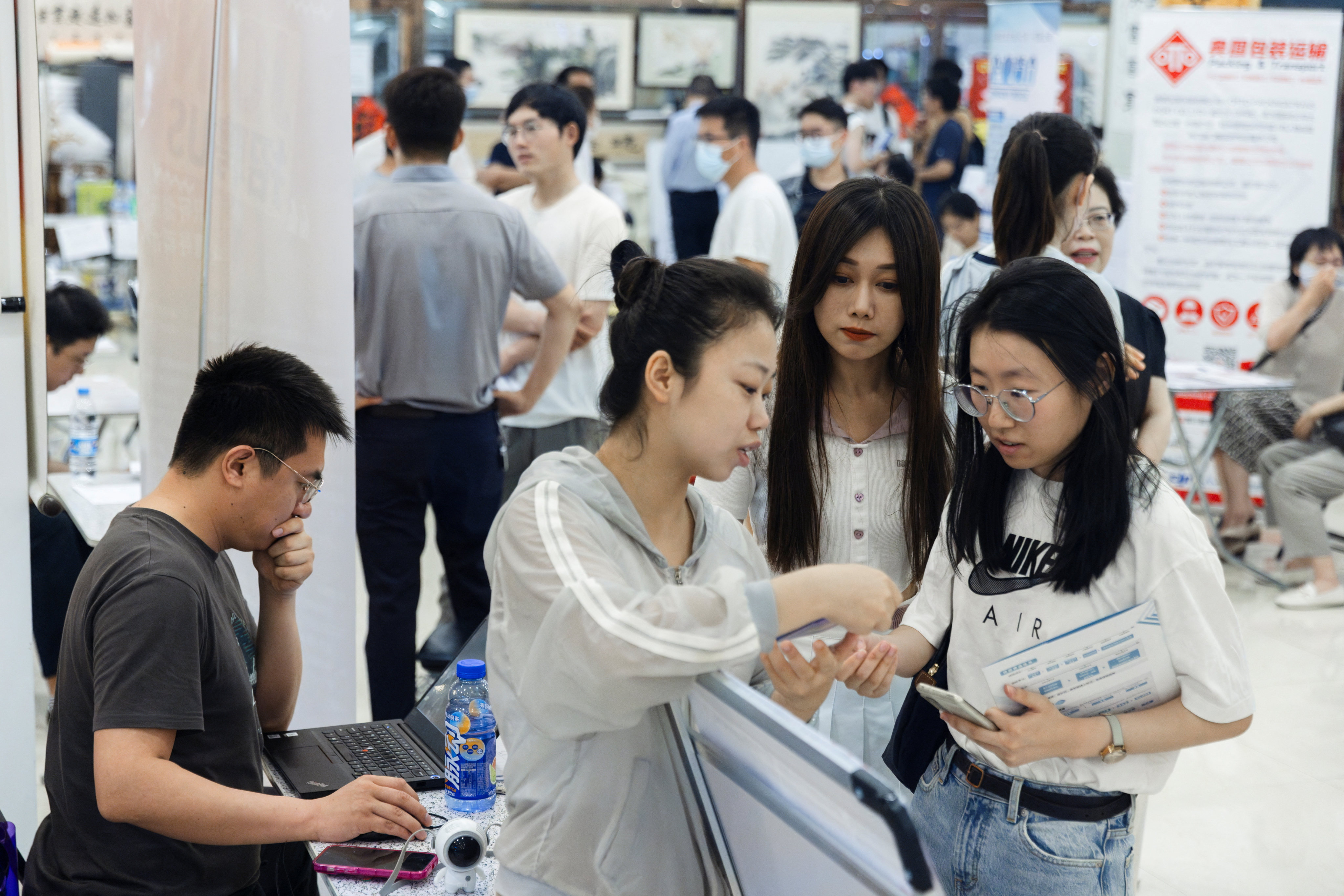 People attend a job fair in a mall in Beijing. Photo: Reuters