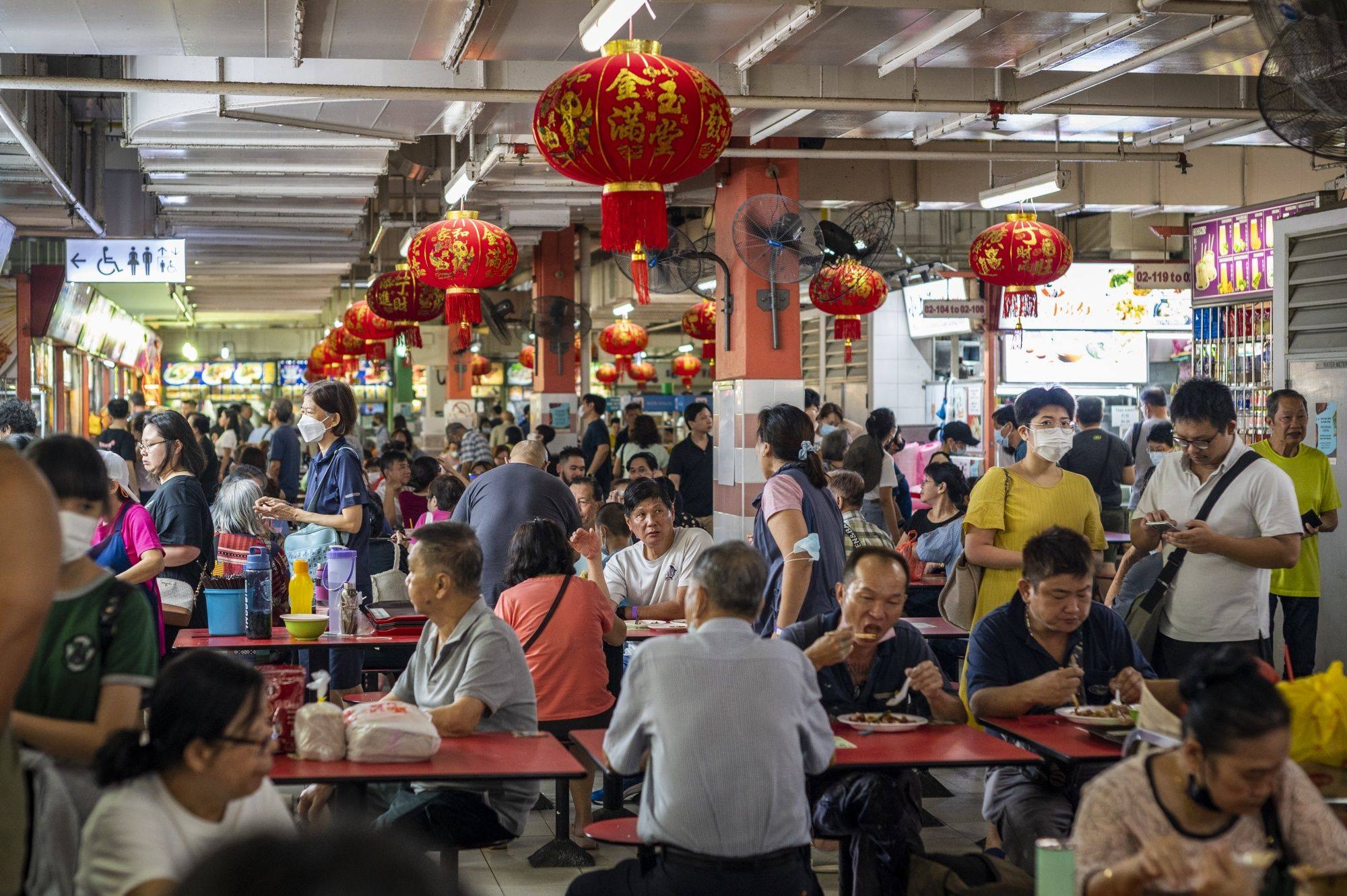 Customers have their lunch at a hawker centre in Singapore’s Chinatown earlier this year. Some locals believe that the surge in popularity has affected the overall eating experience at Michelin-recognised hawkers. Photo: Bloomberg
