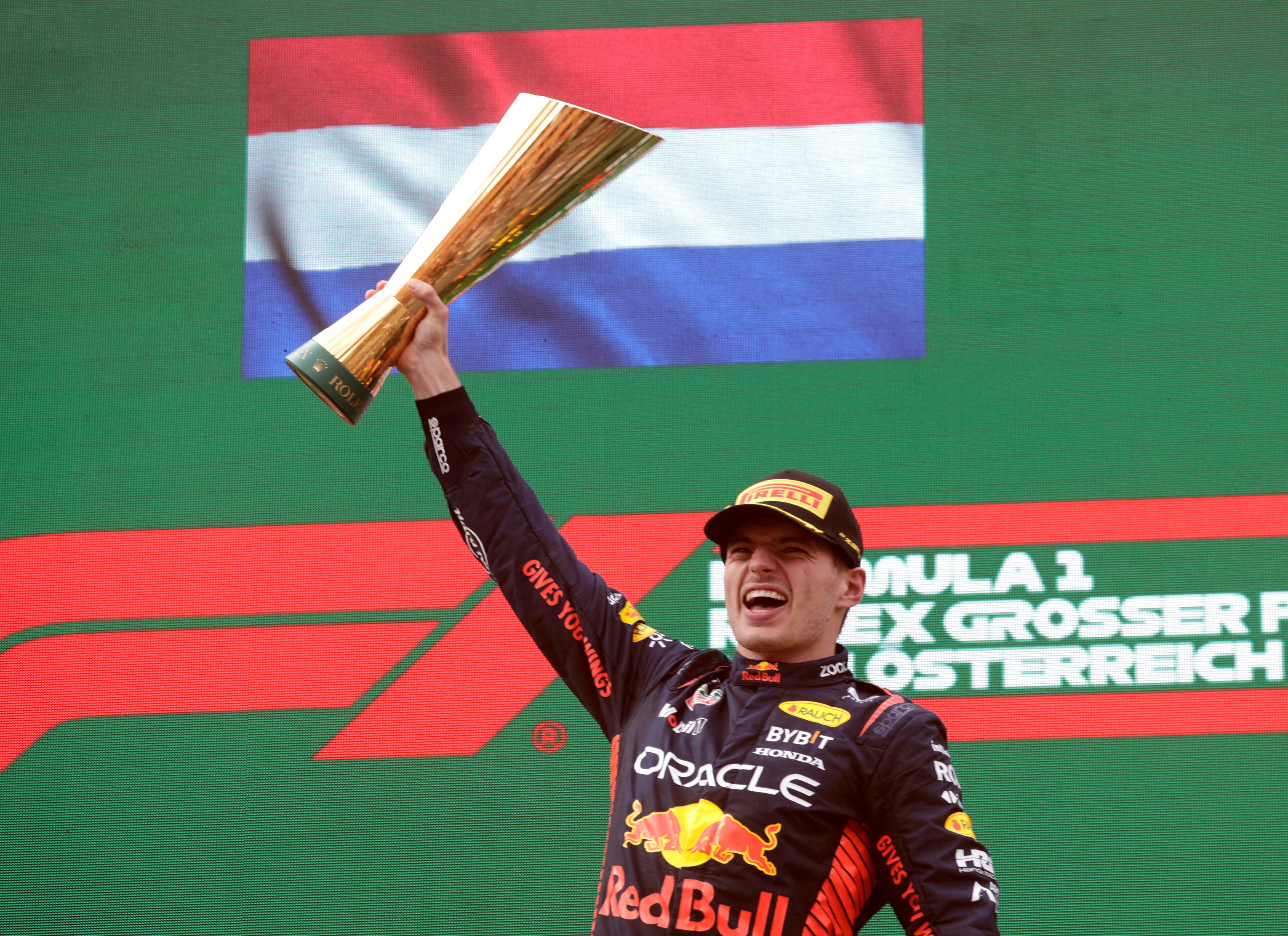 Red Bull’s Max Verstappen celebrates with a trophy on the podium after winning the Austrian Grand Prix. Photo: Reuters