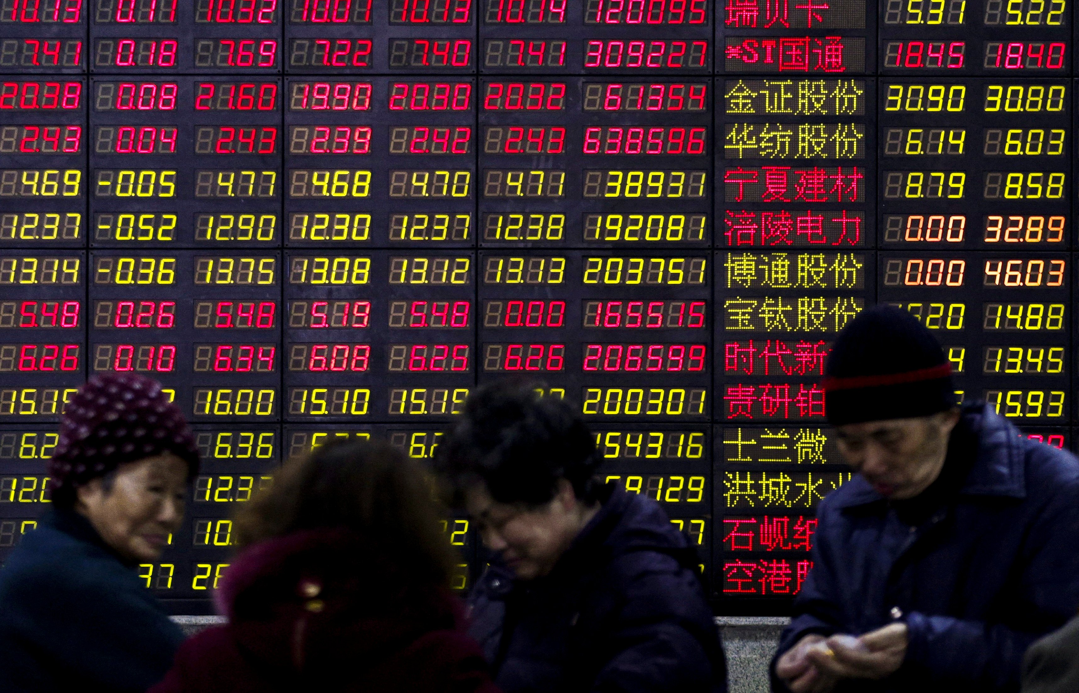 Investors stand in front of an electronic board showing stock information on the first trading day after the week-long Lunar New Year holiday at a brokerage house in Shanghai, China. Chinese companies raised a combined US$31.3 billion from IPO flotations on the Shanghai, Shenzhen and Beijing exchanges in the six months to June. Photo: Reuters