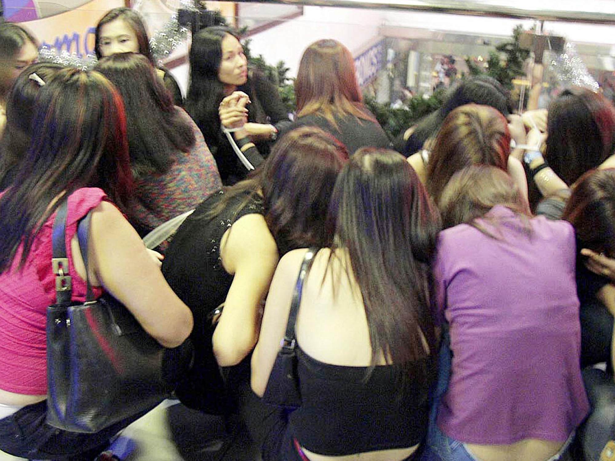 Foreign nationals are seen gathered outside a nightclub in Singapore’s Orchard Towers following a major police anti-vice operation in 2001. Photo: Singapore Police Force via AFP