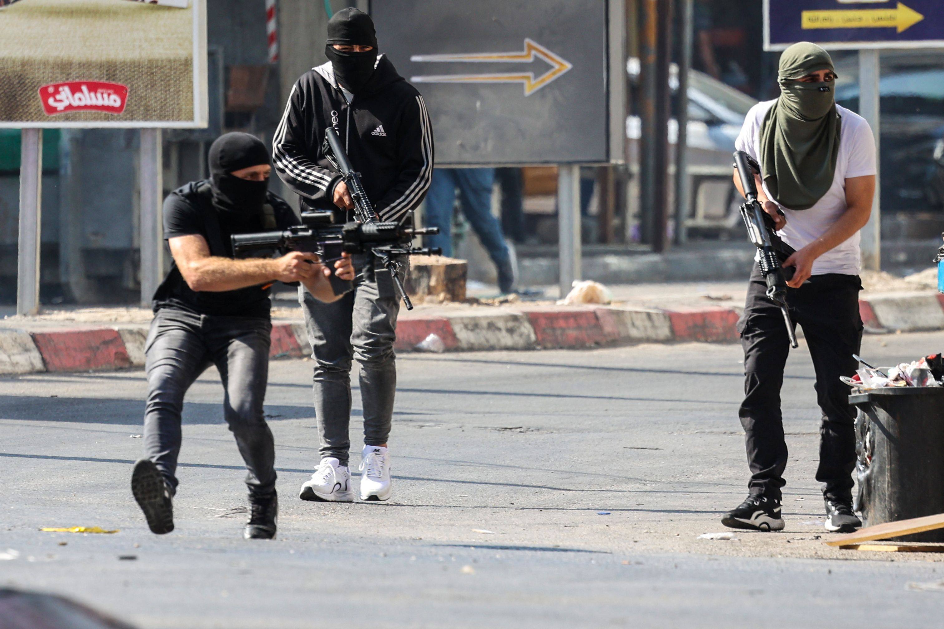Palestinian militants take up position during a confrontation with Israeli army in the occupied West Bank city of Jenin on Monday. Photo: AFP