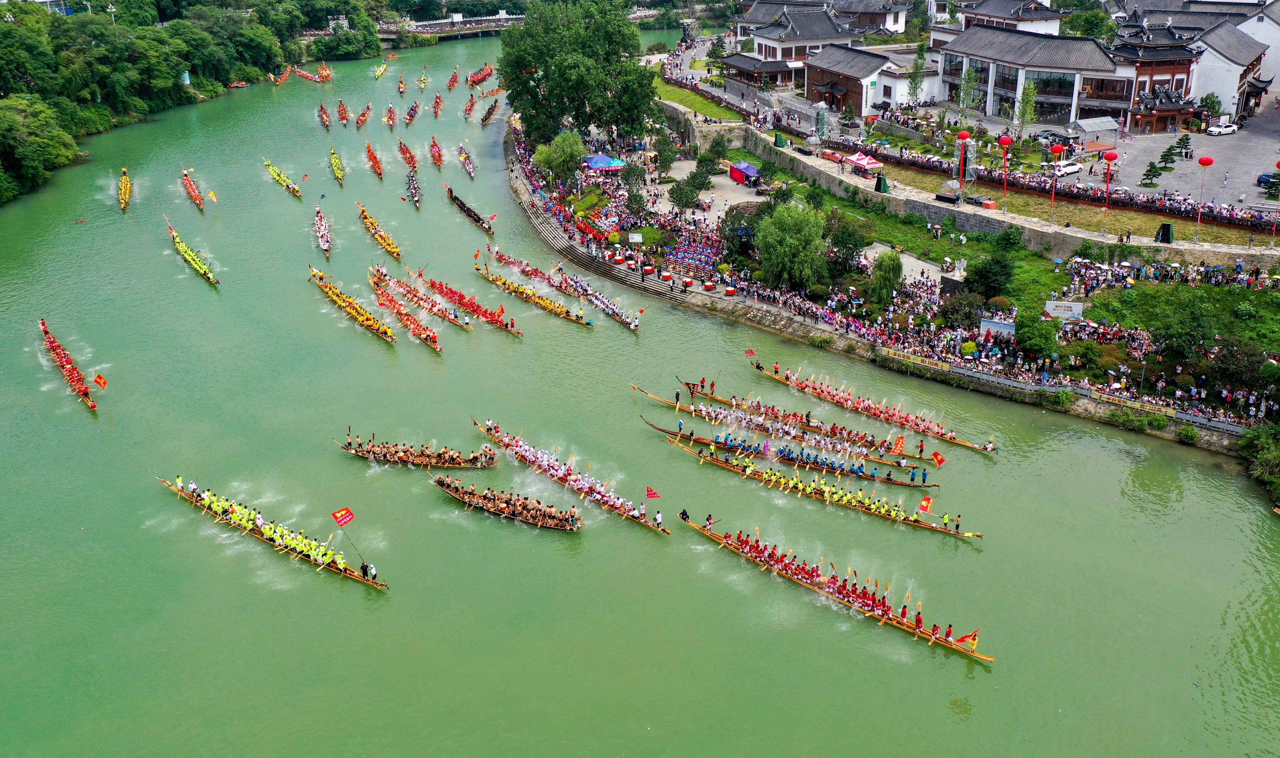 A dragon boat parade on the Jinjiang River in Tongren city, Guizhou province.  The poor southwestern Chinese province reached an agreement with banks late last year to extend loans of about US$2.3 billion by 20 years. Photo: Xinhua