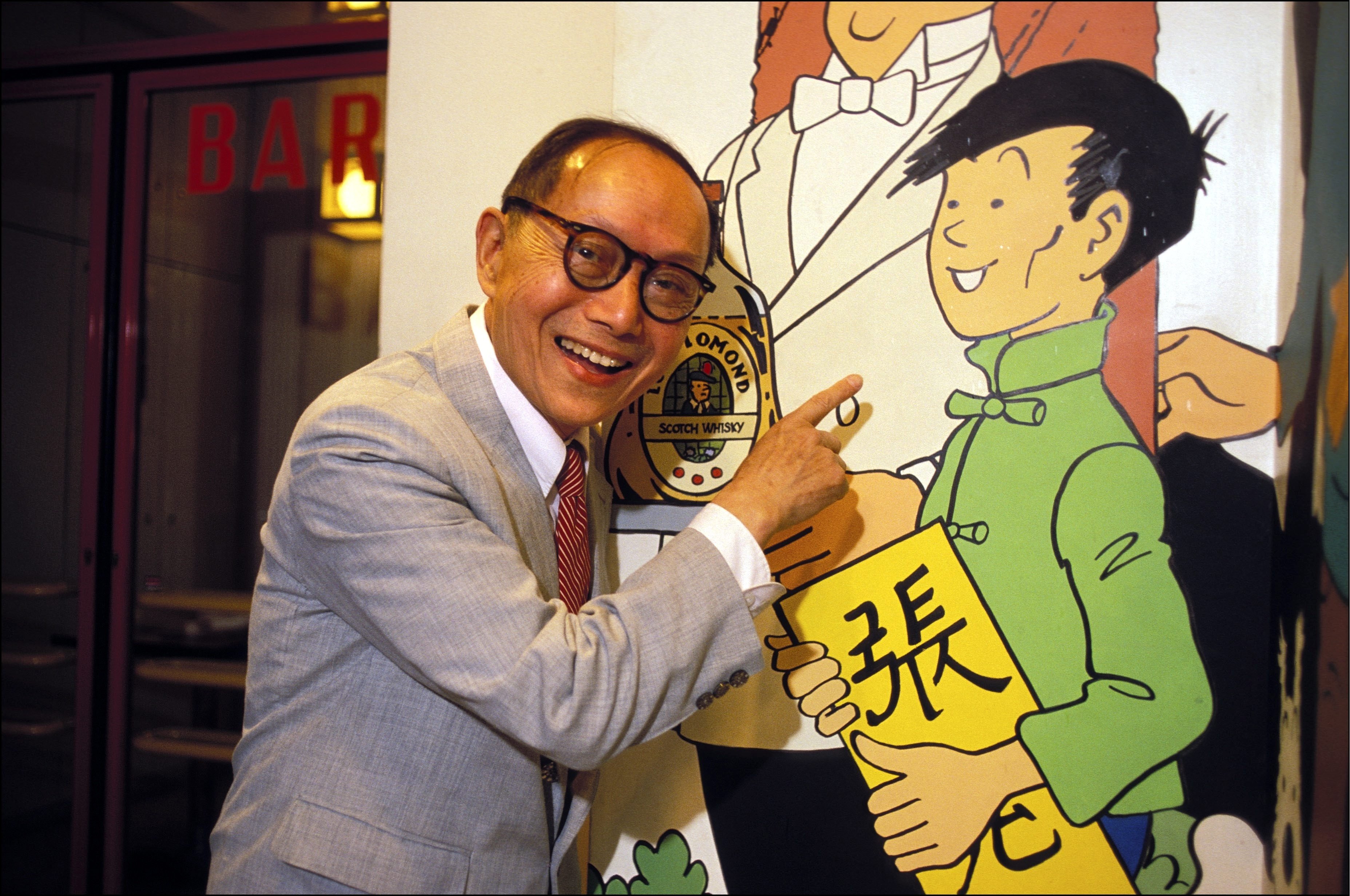 Zhang Chongren points to a poster of Chang Chong-chen, a character in Tintin book The Blue Lotus based on him, in Paris in 1985. The leading Chinese artist and Georges Remi, known as Hergé and author of the books, became firm friends after meeting in the 1930s. Photo: Getty Images