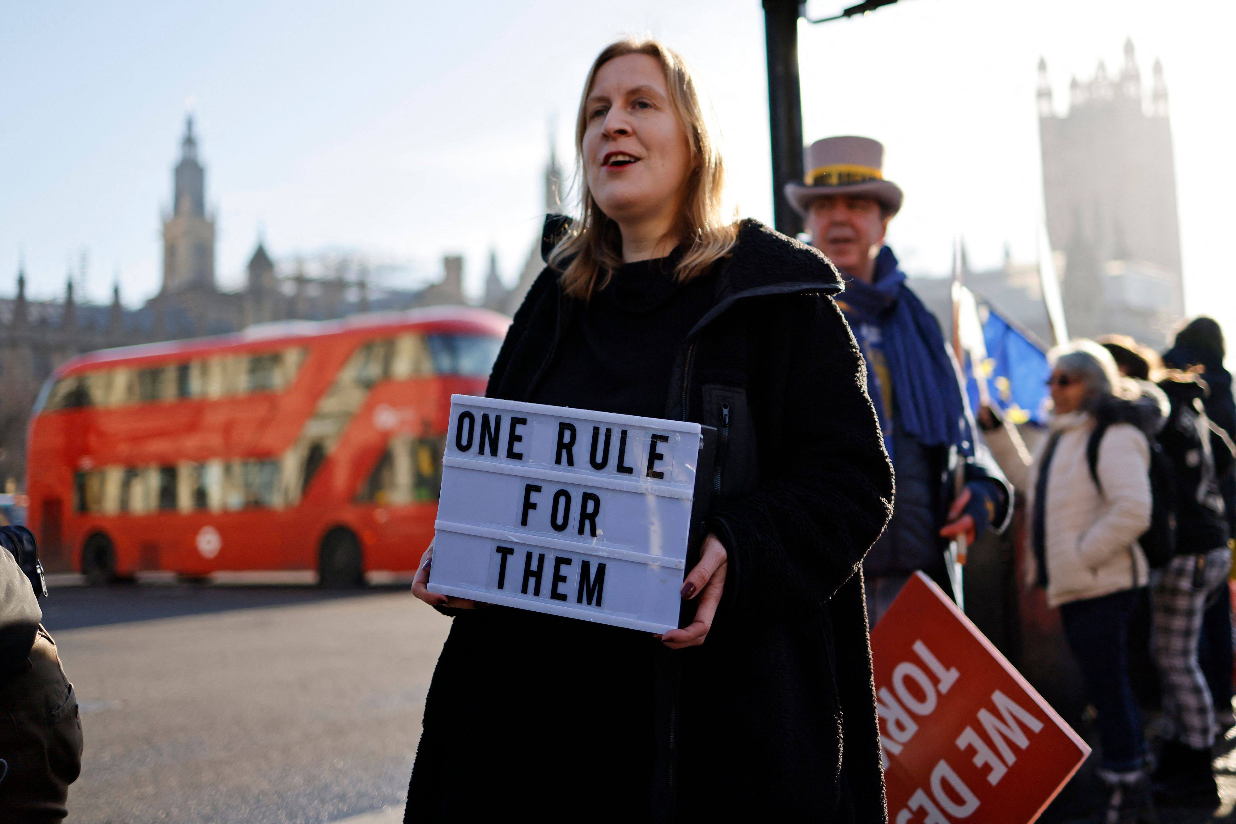 Protesters near the House of Commons in London in January 2022 after former Prime Minister Boris Johnson apologised for attending a coronavirus lockdown-breaching party in Downing Street. Photo: AFP