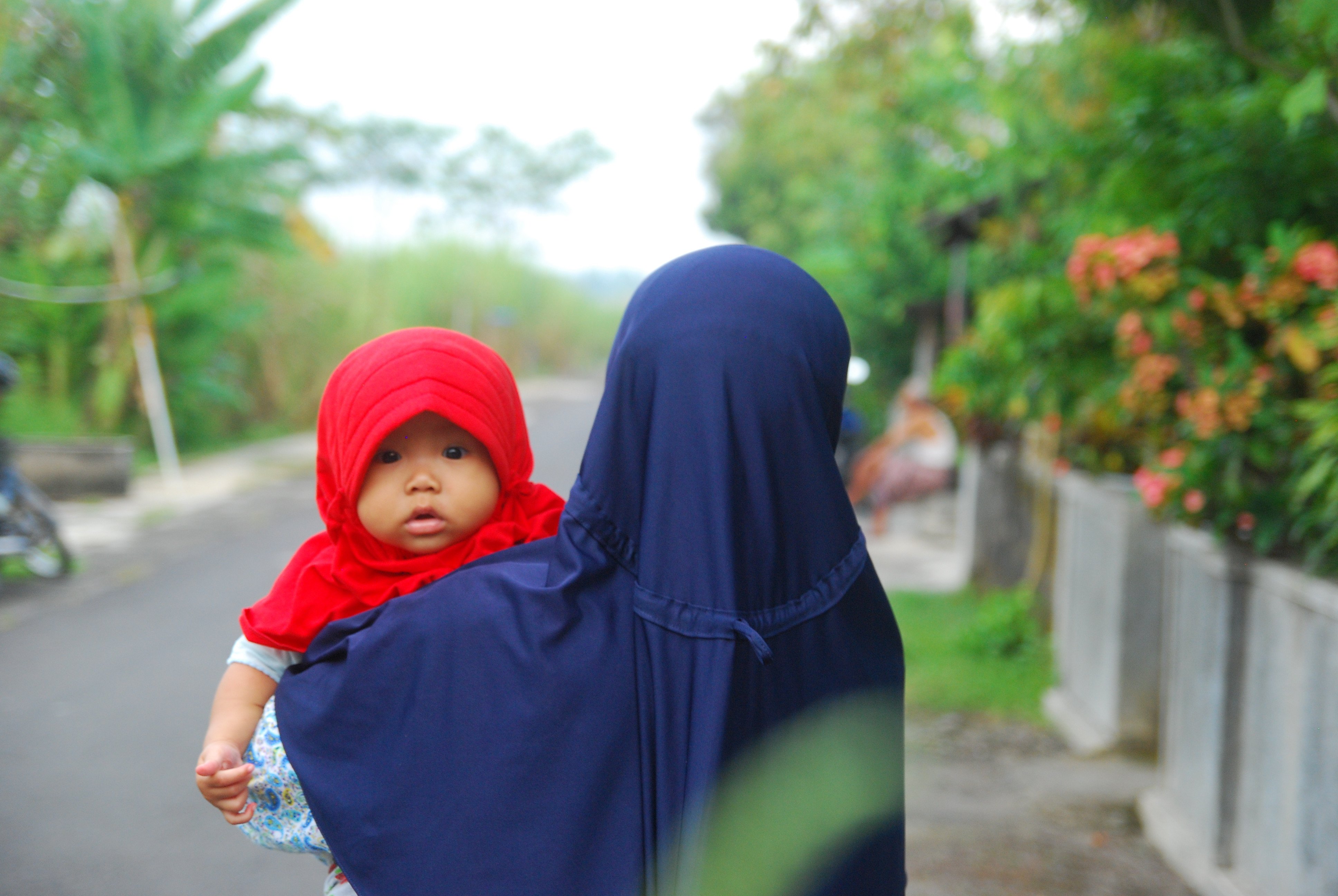 A woman carries her baby in Yogyakarta, Indonesia. Photo: Shutterstock 