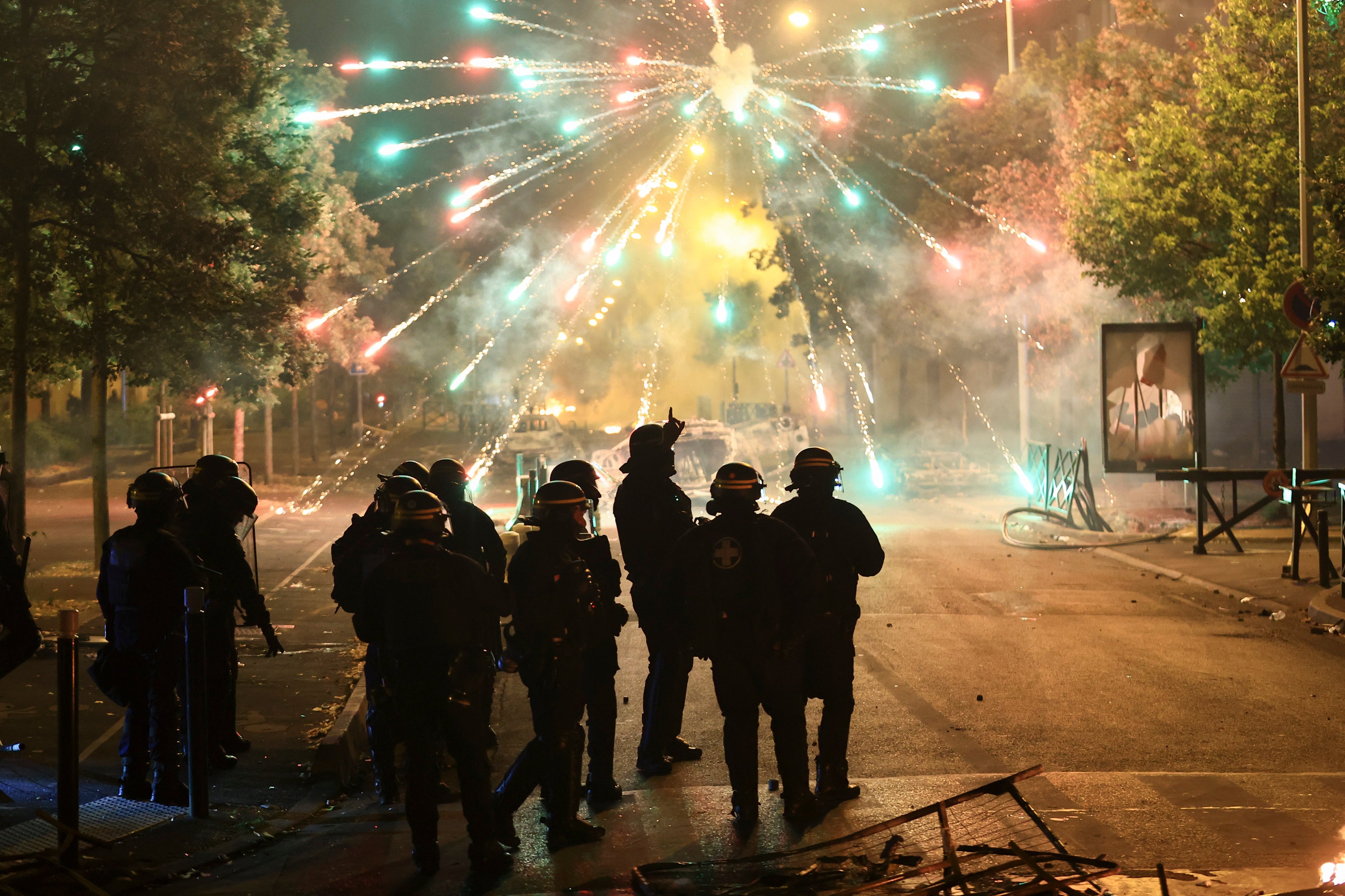 Police stand amid firecrackers on the third night of protests sparked by the fatal police shooting of a 17-year-old in the Paris suburb of Nanterre on June 30. The role of TikTok and other social media platforms in protests across France has come under scrutiny from President Emmanuel Macron and other politicians. Photo: AP