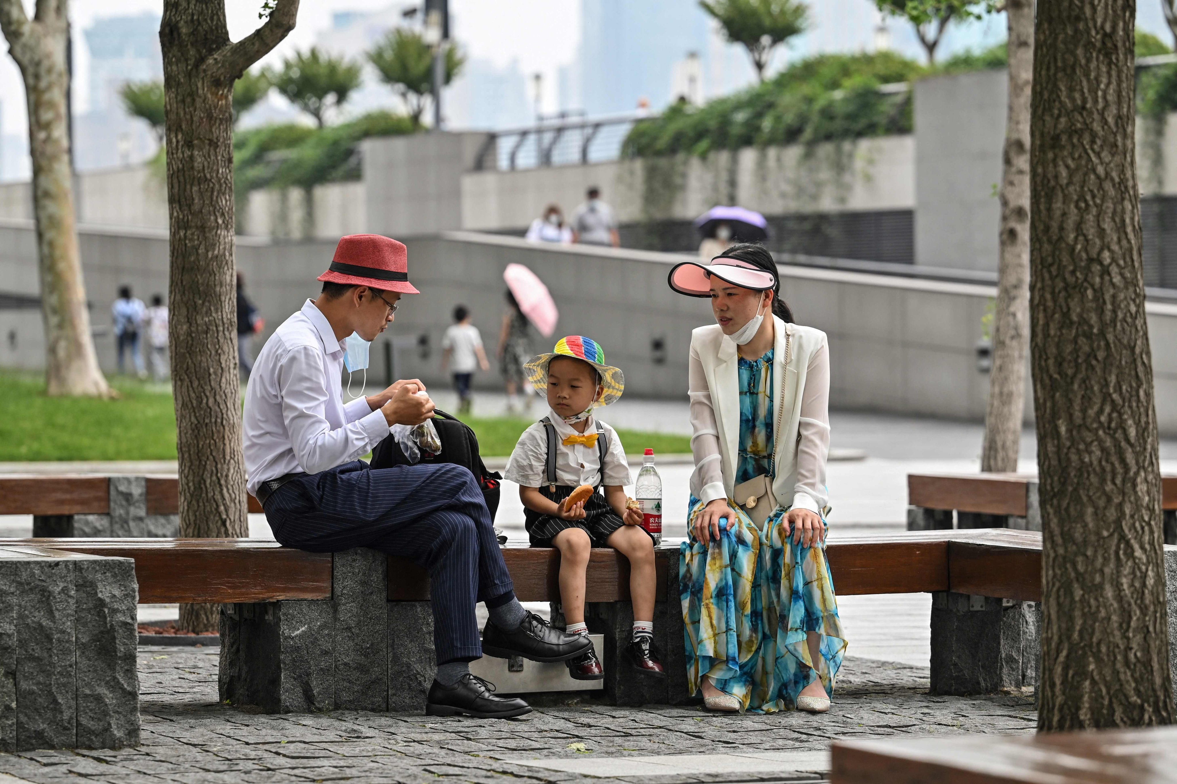 A family sits in a park on the Bund in the Huangpu district of Shanghai. Photo: AFP