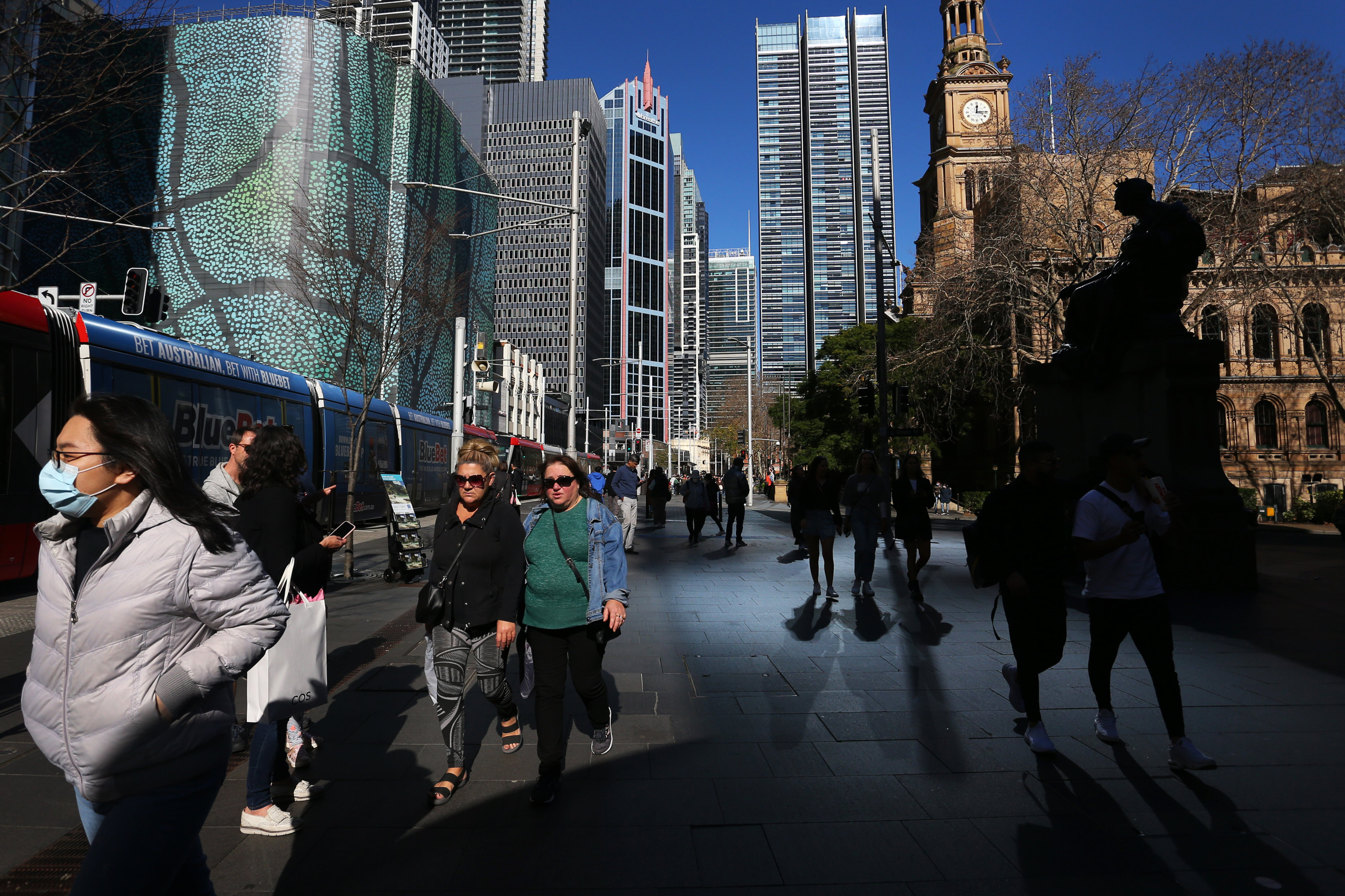 Pedestrians and shoppers make their way through the central business district of Sydney last summer. Photo: Getty Images