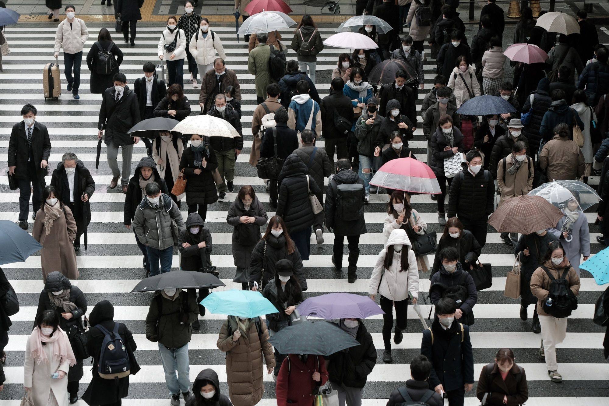 Pedestrians cross a road in Osaka, Japan, on February 13. Japan’s female labour force participation rate lags many other developed economies, but it has seen some gains in recent years. Photo: Bloomberg
