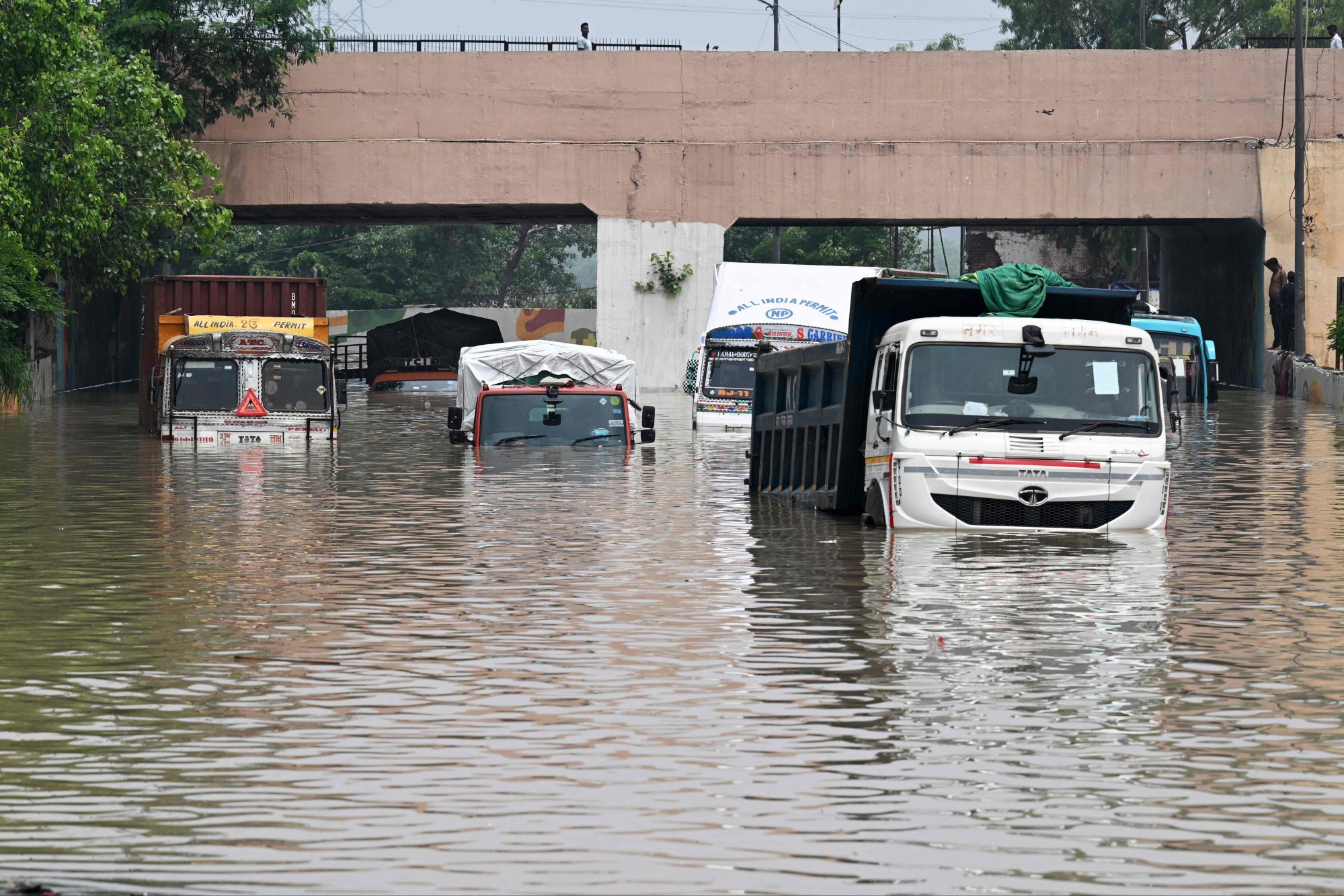 Deadly floods amid record monsoon rains kill at least 100 people in ...