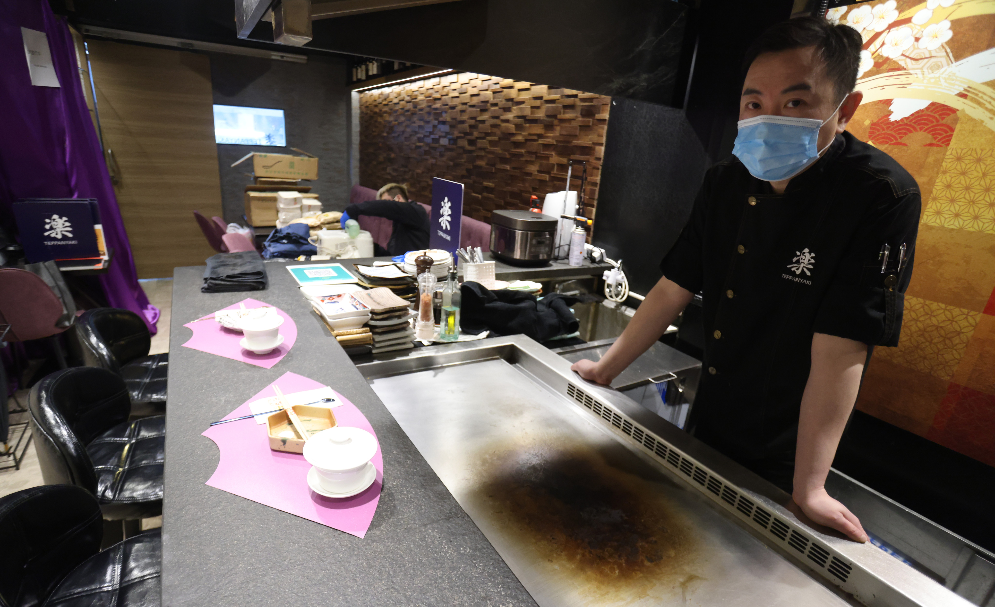 Cheng Wai-lok who operates a Japanese Teppanyaki restaurant in Jordan, looks at empty tables at his outlet. Photo: May Tse