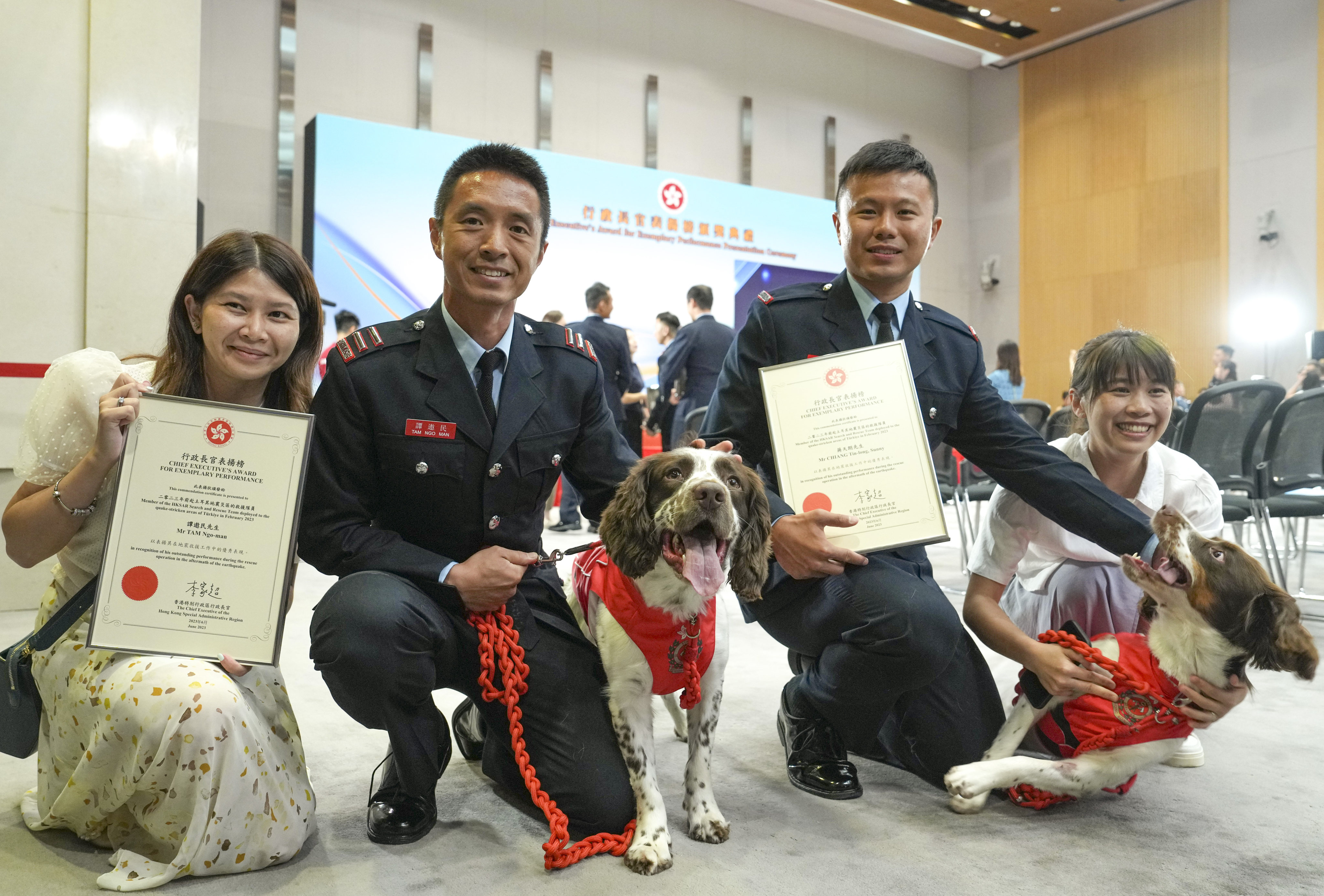 Firefighters Tam Ngo-man (second left) and Chiang Tin-long with rescue dogs Umi and Twix and proud members of their families after a Hong Kong team was given the Chief Executive’s Award for Exemplary Performance for their mercy mission to earthquake-stricken Turkey.
Photo: Elson Li