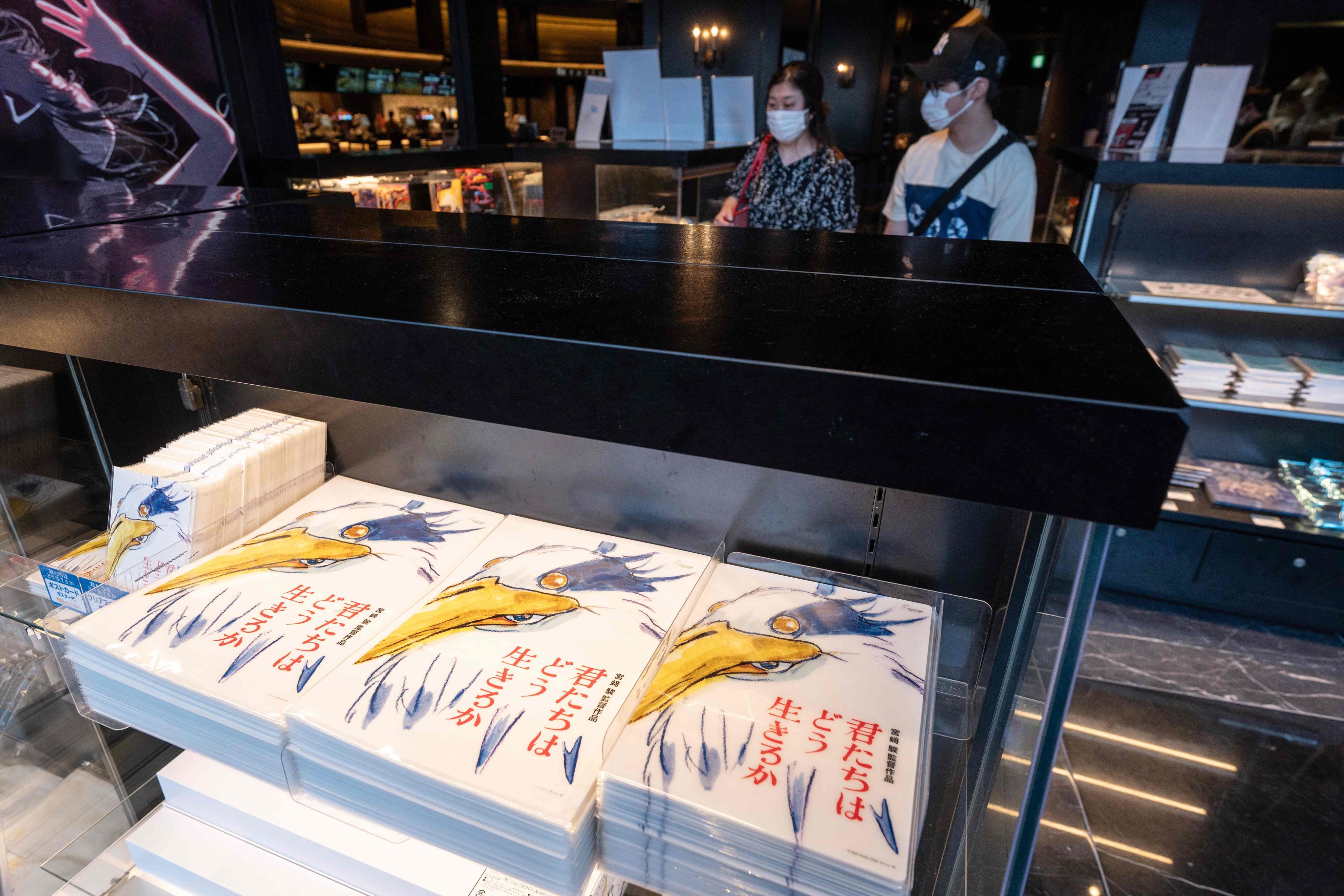 Merchandise for Oscar-winning animator Hayao Miyazaki’s latest film, “How Do You Live?” is displayed for sale at a cinema in Tokyo on the first day of its screening in Japan. Photo: AFP