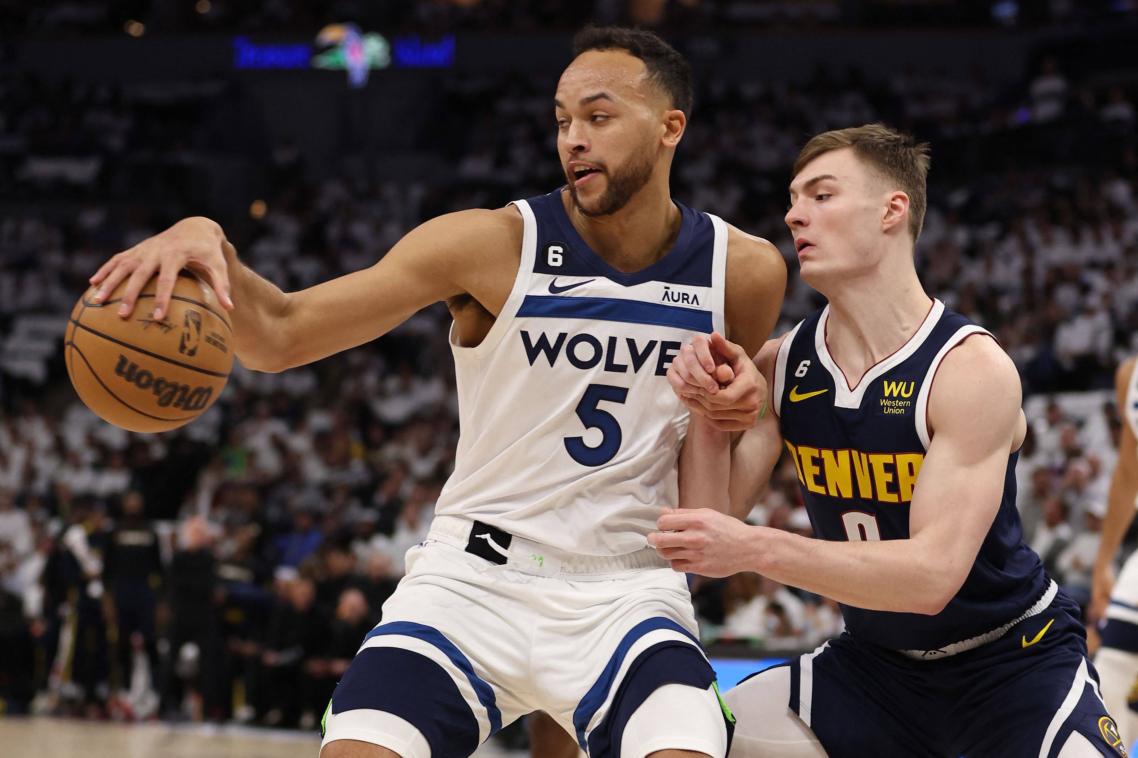 MINNEAPOLIS, MINNESOTA - APRIL 23: Christian Braun #0 of the Denver Nuggets defends against Kyle Anderson (left) battles past Christian Braun of the Denver Nuggets during an NBA game at the Target Centre in Minneapolis. Photo: AFP