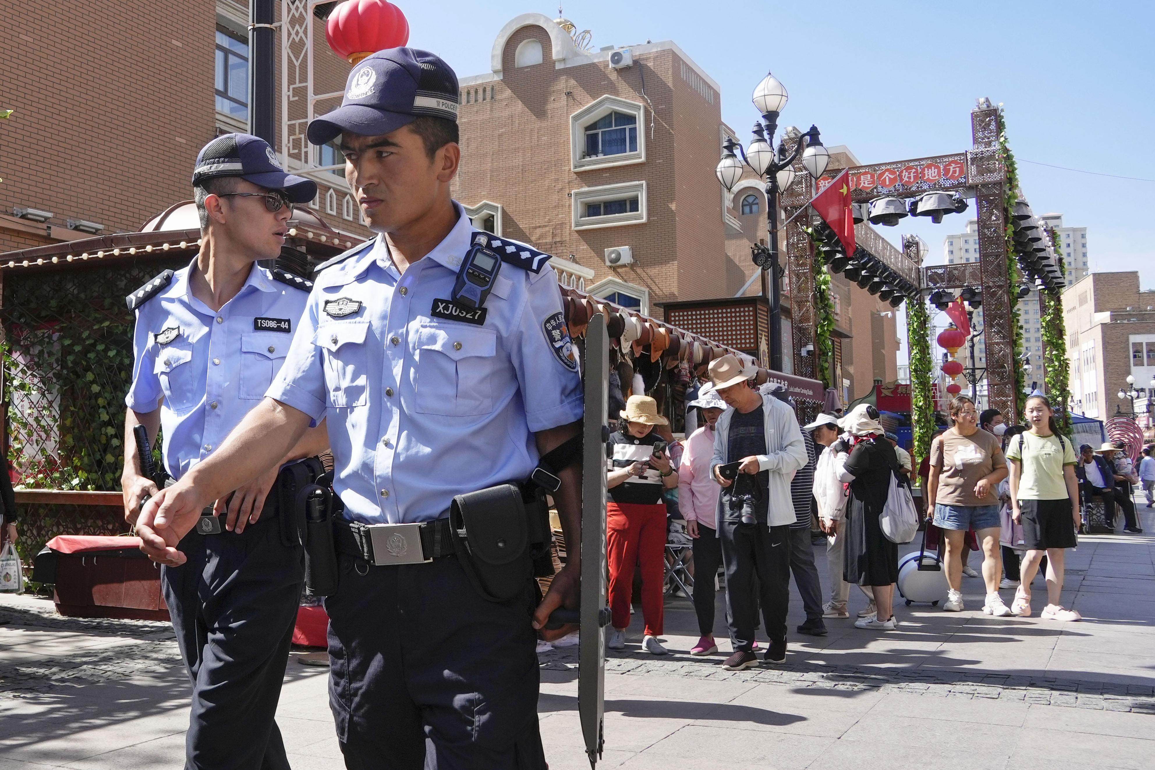 Armed police officers stand guard at the Grand Bazaar in Urumqi, Xinjiang. Photo: Kyodo