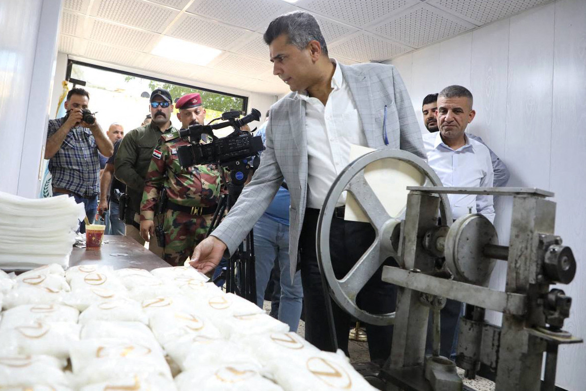 Iraq’s Interior Ministry spokesman General Saad Maan inspects bags of Captagon pills, after a site for Captagon production was found in a province bordering Saudi Arabia on Sunday. Photo: Iraqi Interior Ministry / AFP