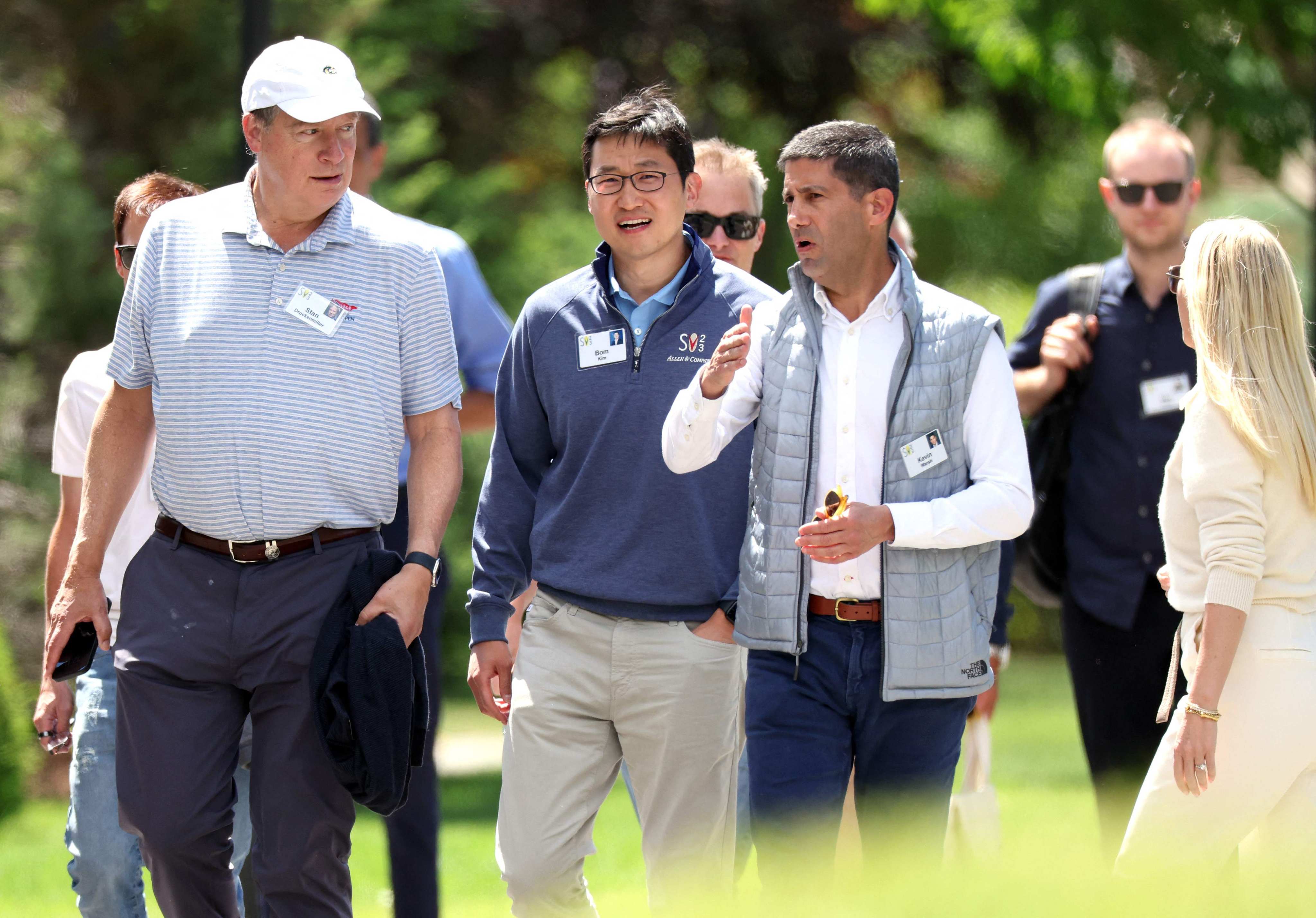 Bom Kim (centre), founder and CEO of Coupang, walks with investor Stan Druckenmiller and member of the Federal Reserve Board of Governors Kevin Warsh at the Allen & Company Sun Valley Conference on July 13, in Sun Valley, Idaho. Photo: AFP