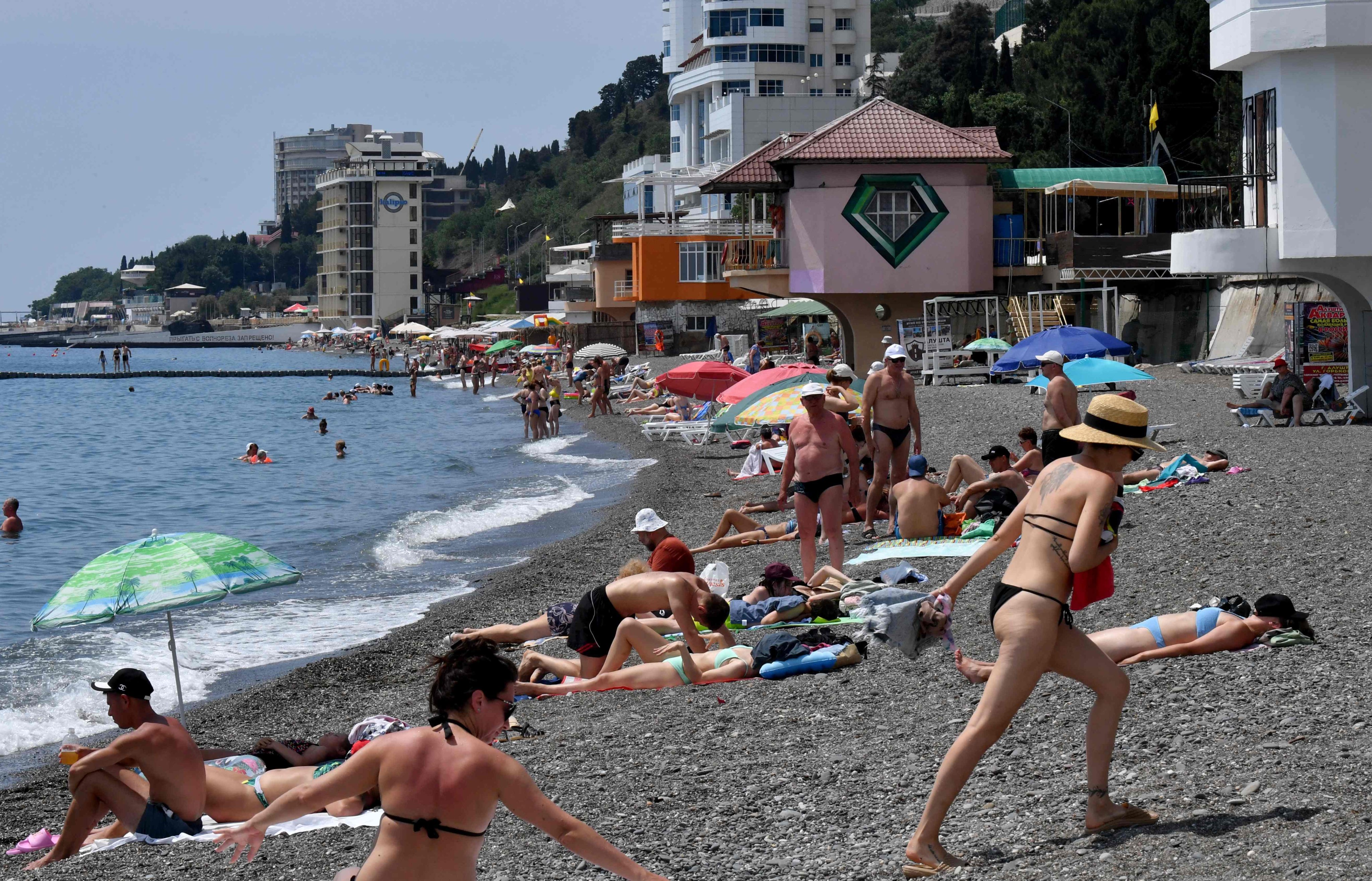 People relax on a beach in the resort town of Alushta on the Crimean peninsula in June. Photo: AFP
