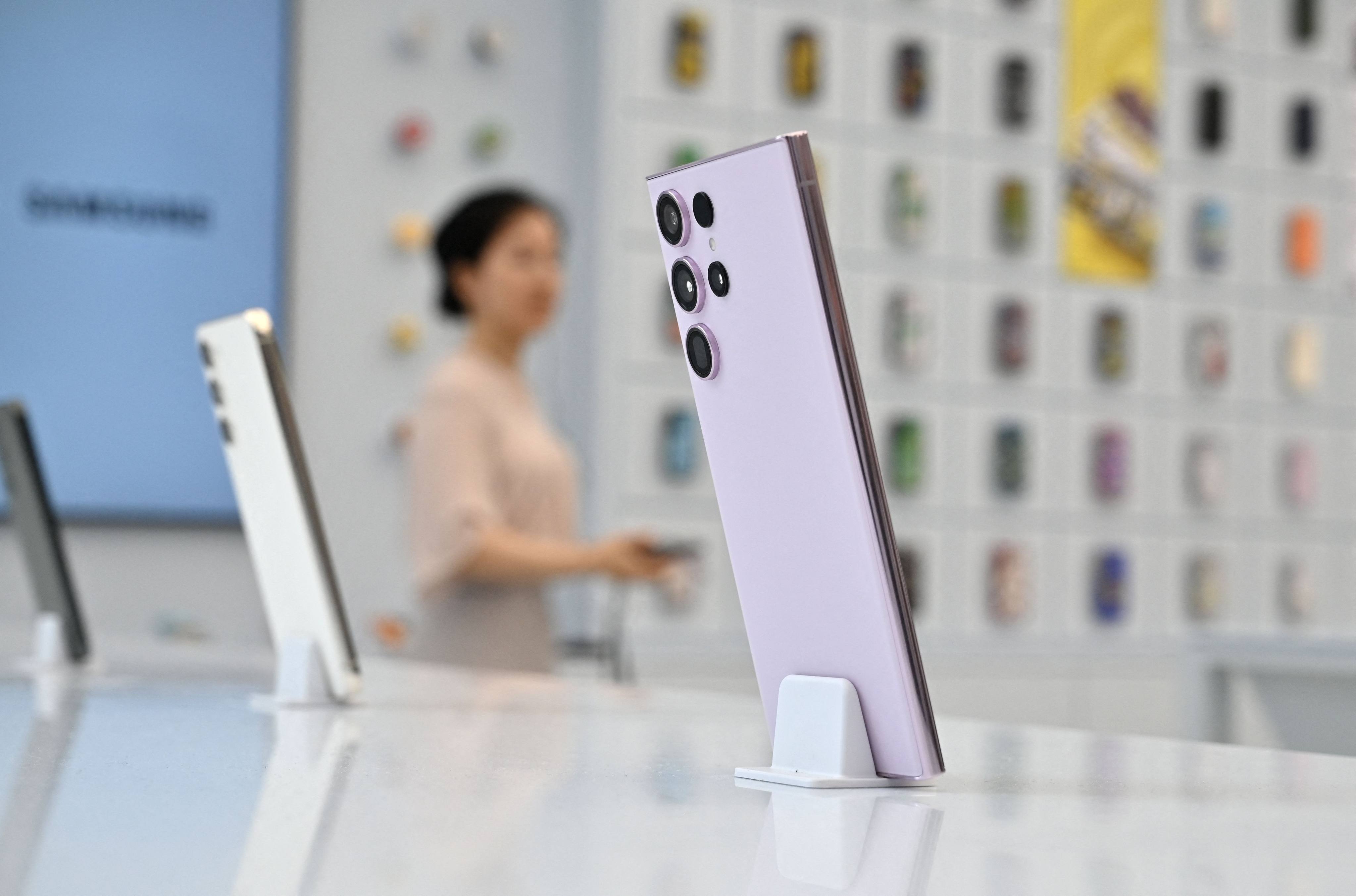 A woman walks past a Samsung Electronics display of its Galaxy S23 Ultra smartphone during a media preview event for the South Korean giant’s new flagship store at the Gangnam district in Seoul on June 28, 2023. Photo: Agence France-Presse