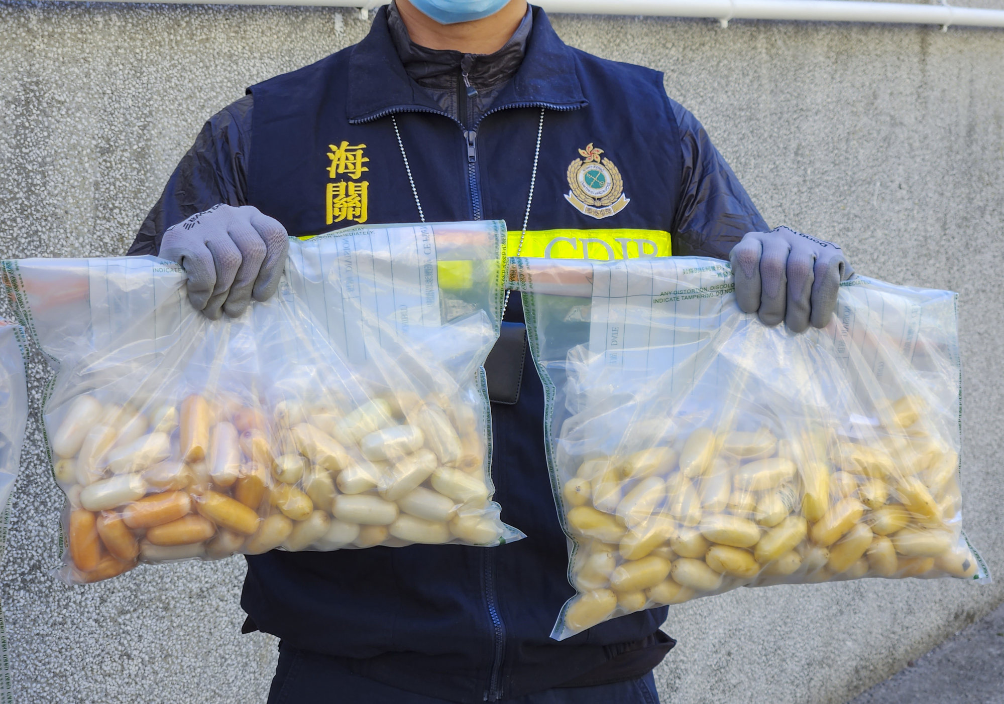 A customs officer displays 6.3kg of suspected cocaine found in biscuit tins in a tourist’s luggage this month. Photo: Harvey Kong