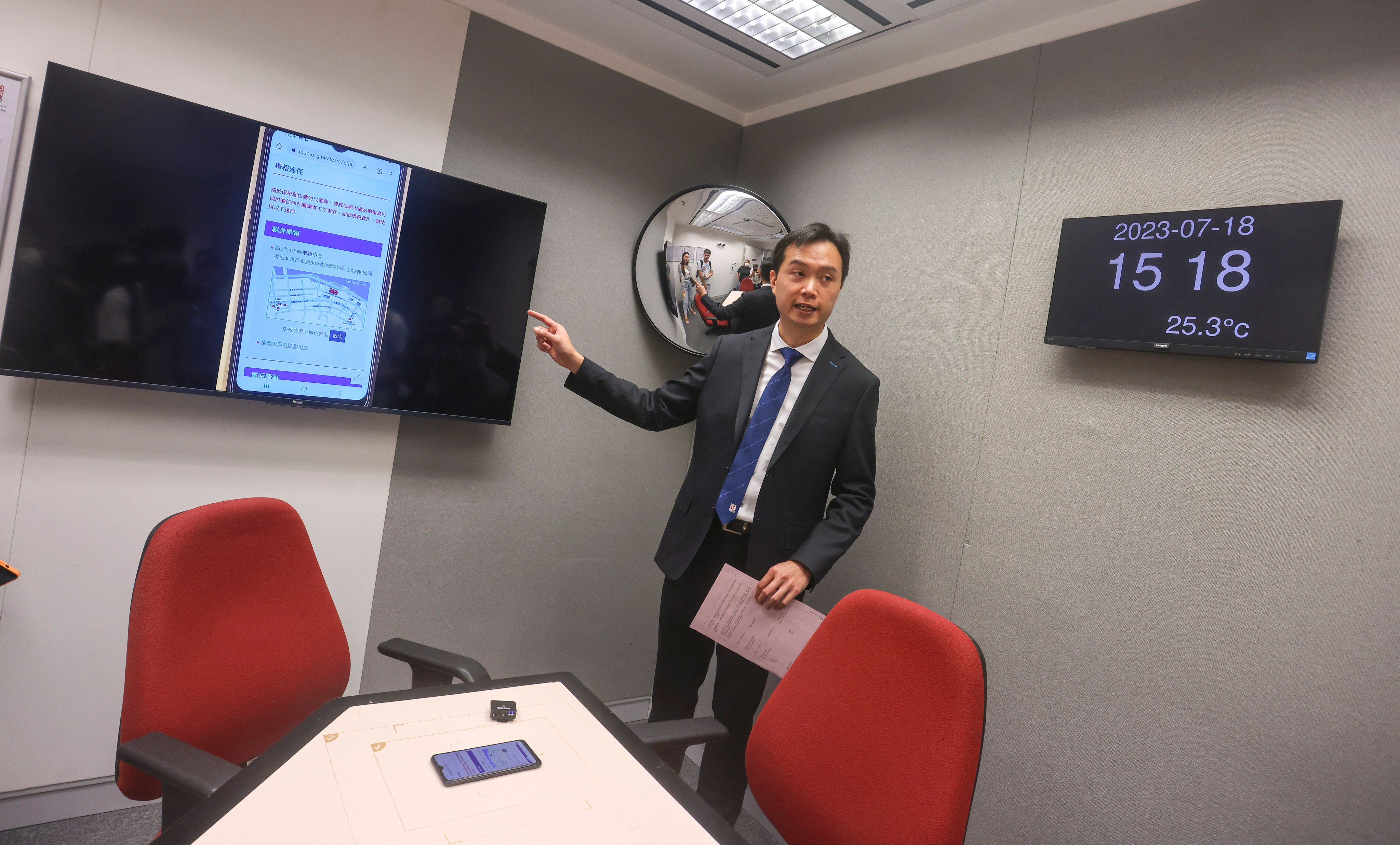 An ICAC official displays new-generation interview rooms, part of technologies covered in its UN workshops. Photo: Jonathan Wong