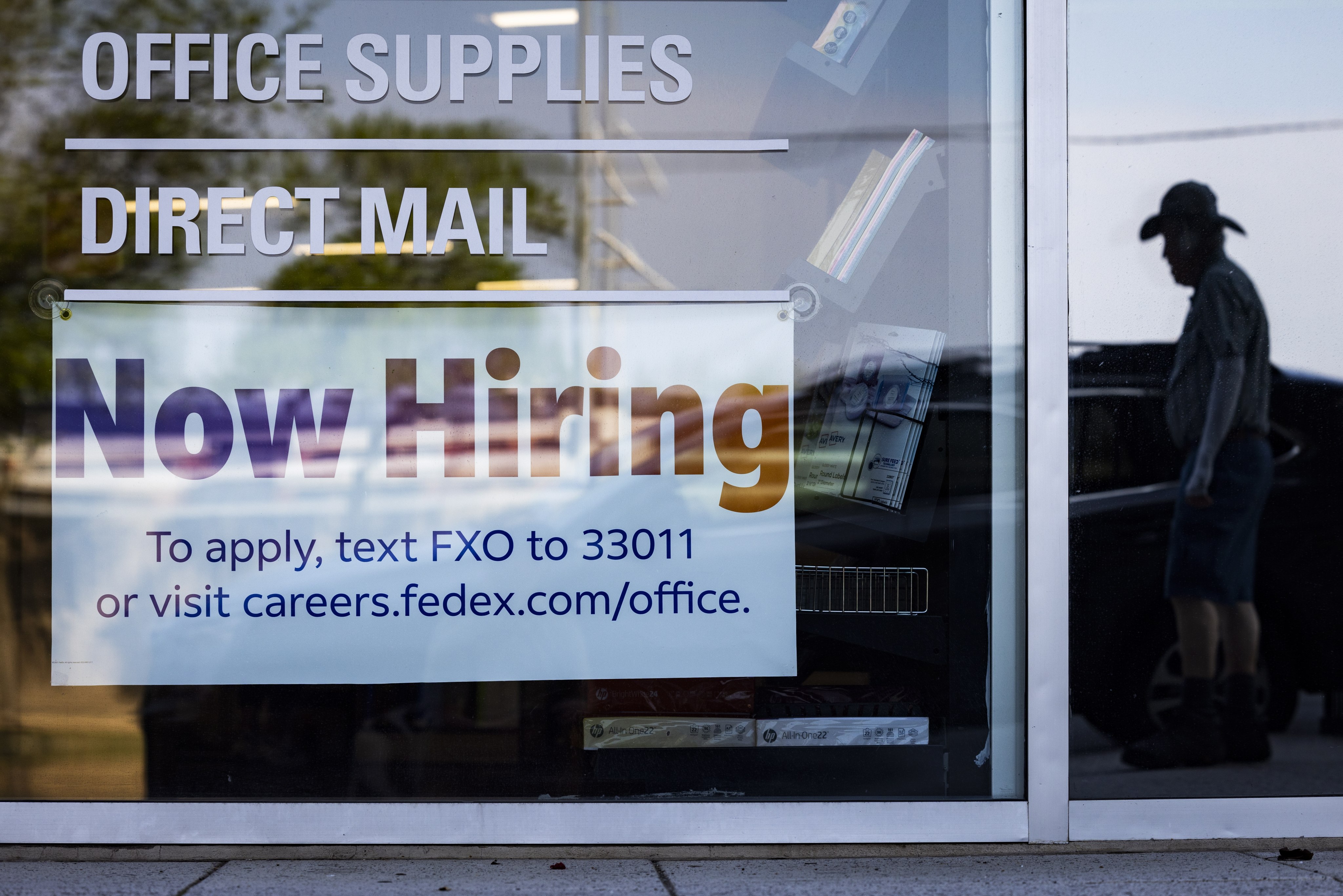 A “now hiring” sign on the window of a FedEx office in Washington on July 7. According to the Labour Department, the US economy added 209,000 jobs in June, far fewer than the predicted number of 240,000 jobs. The unemployment rate fell to 3.6 per cent. Photo: EPA-EFE