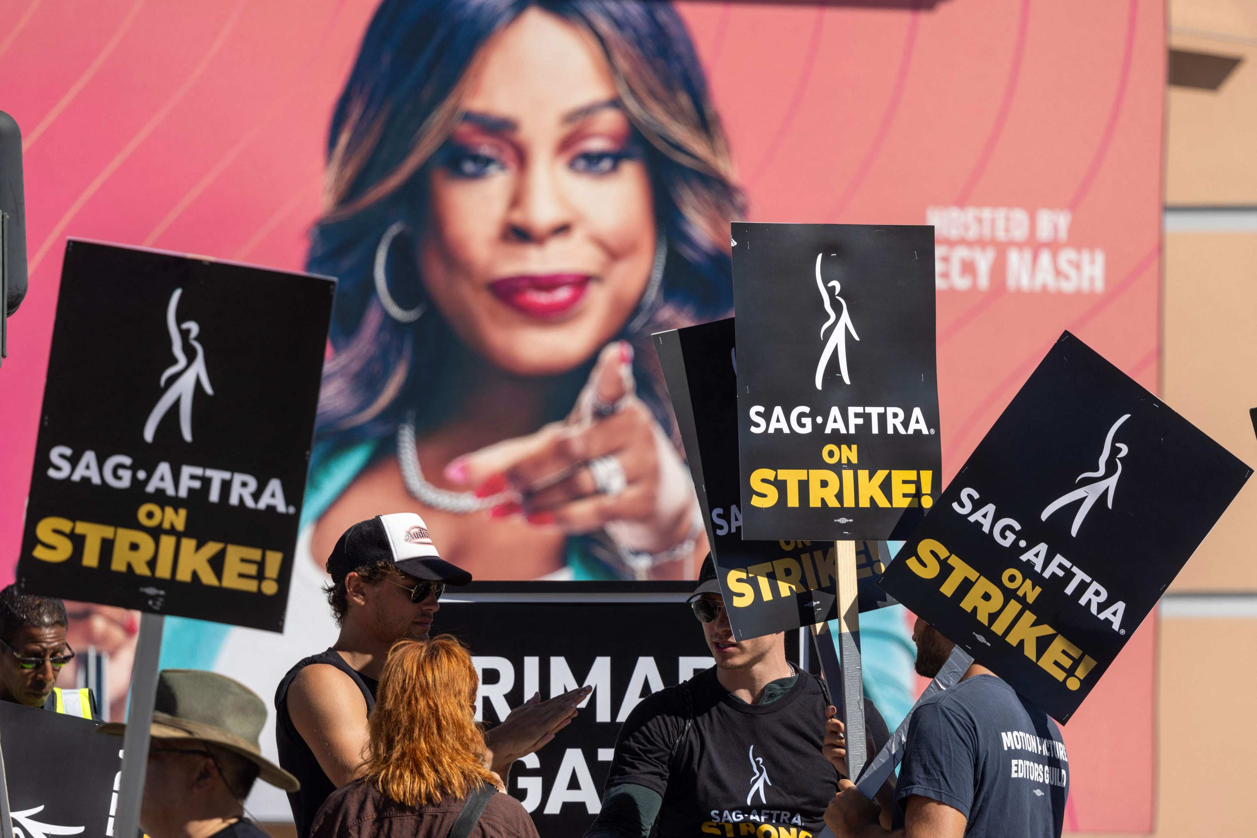 Members of the Hollywood actors’ union are seen at a picket line near an image of “Don’t Forget the Lyrics” host Niecy Nash outside Fox Studios on the first day of the actors’ strike on July 14 in Los Angeles, California. Photo: Getty Images via AFP