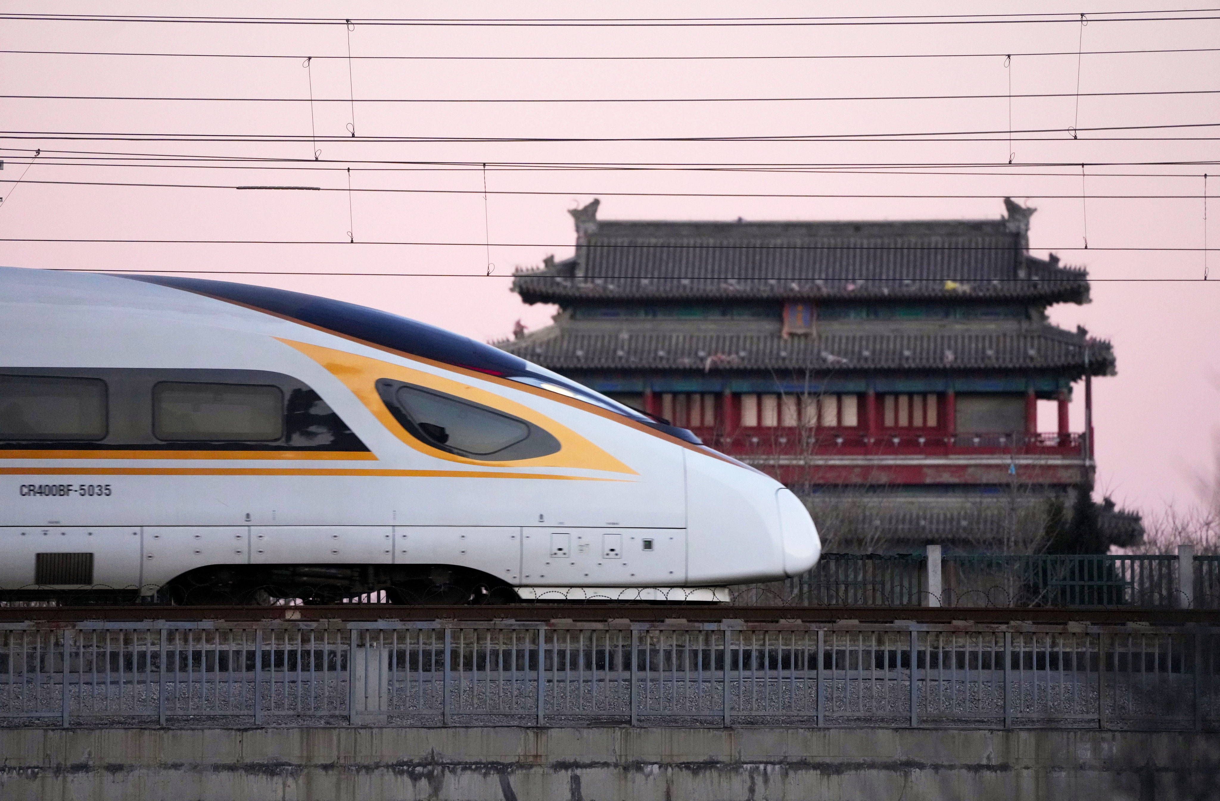 A bullet train passes by the Yongdingmen or Gate of Perpetual Peace in Beijing. China’s high-speed rail makes exploring the country easy, and is less carbon-intensive than air travel. Photo: Xinhua 