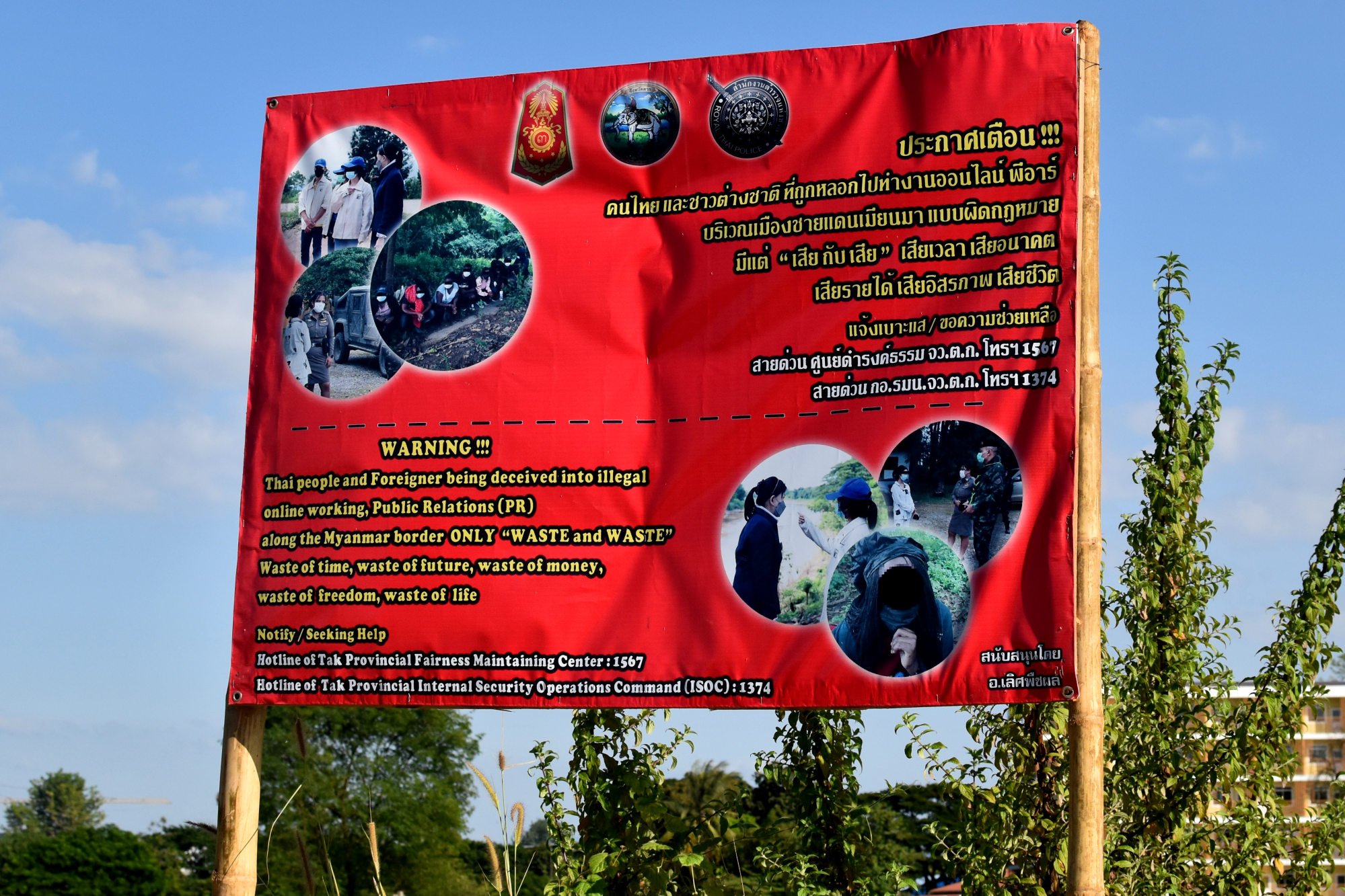 An anti-trafficking sign near the Thailand-Myanmar border warns potential victims not to be “deceived into illegal online working”. Photo: Allegra Mendelson