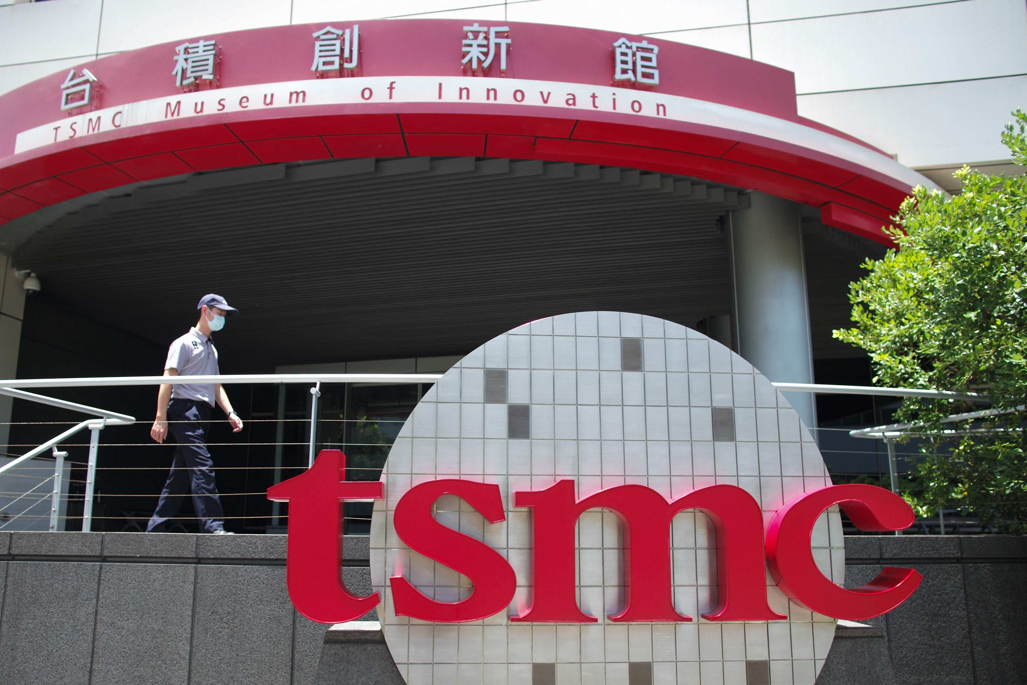 A security staff walks past a TSMC logo at the Hsinchu Science Park in Hsinchu on July 5, 2023. Photo: AFP