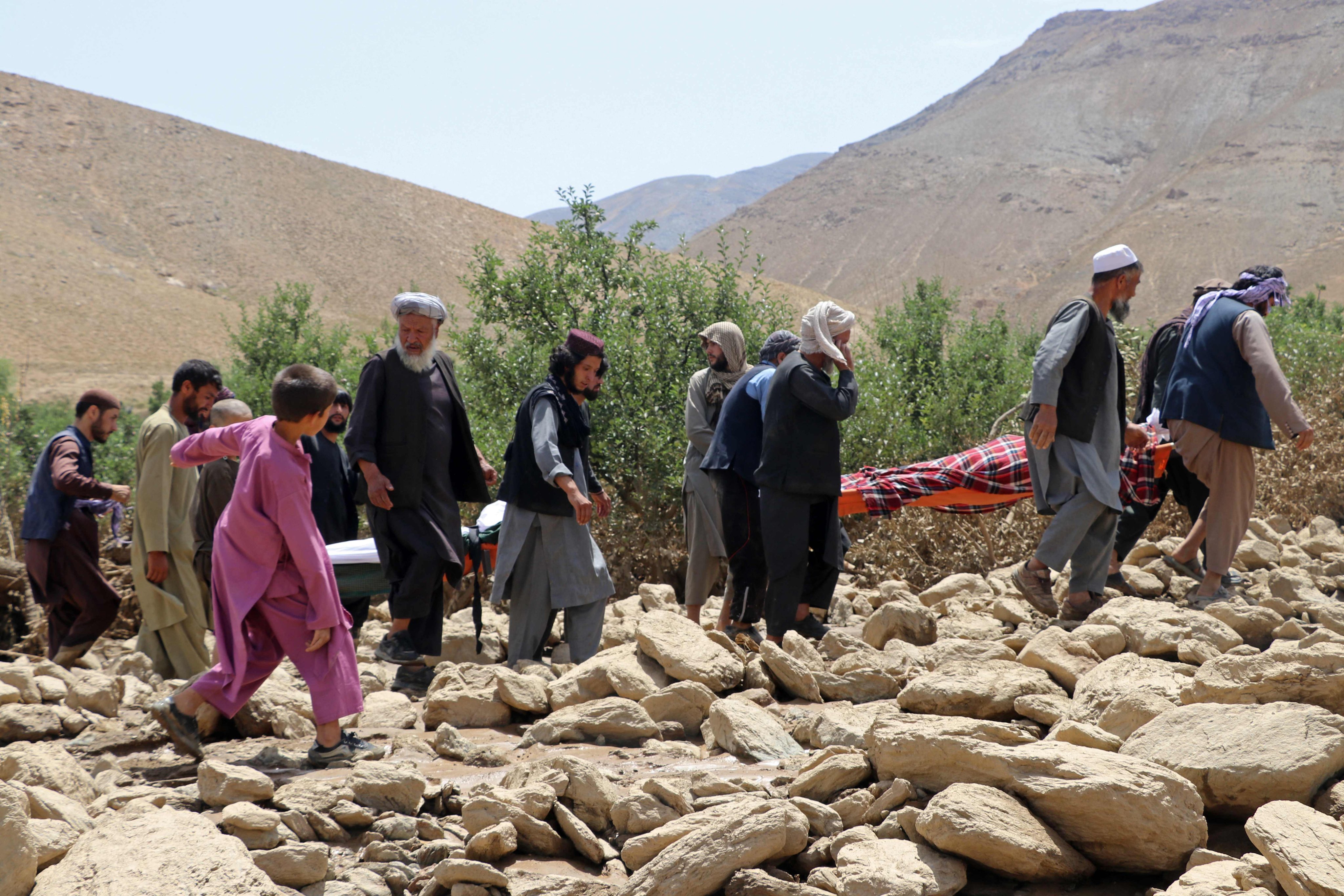 Afghan residents carry the bodies of relatives who died in flash floods in the Jalrez district of Maidan Wardak province, Afghanistan on Sunday. Photo:  AFP