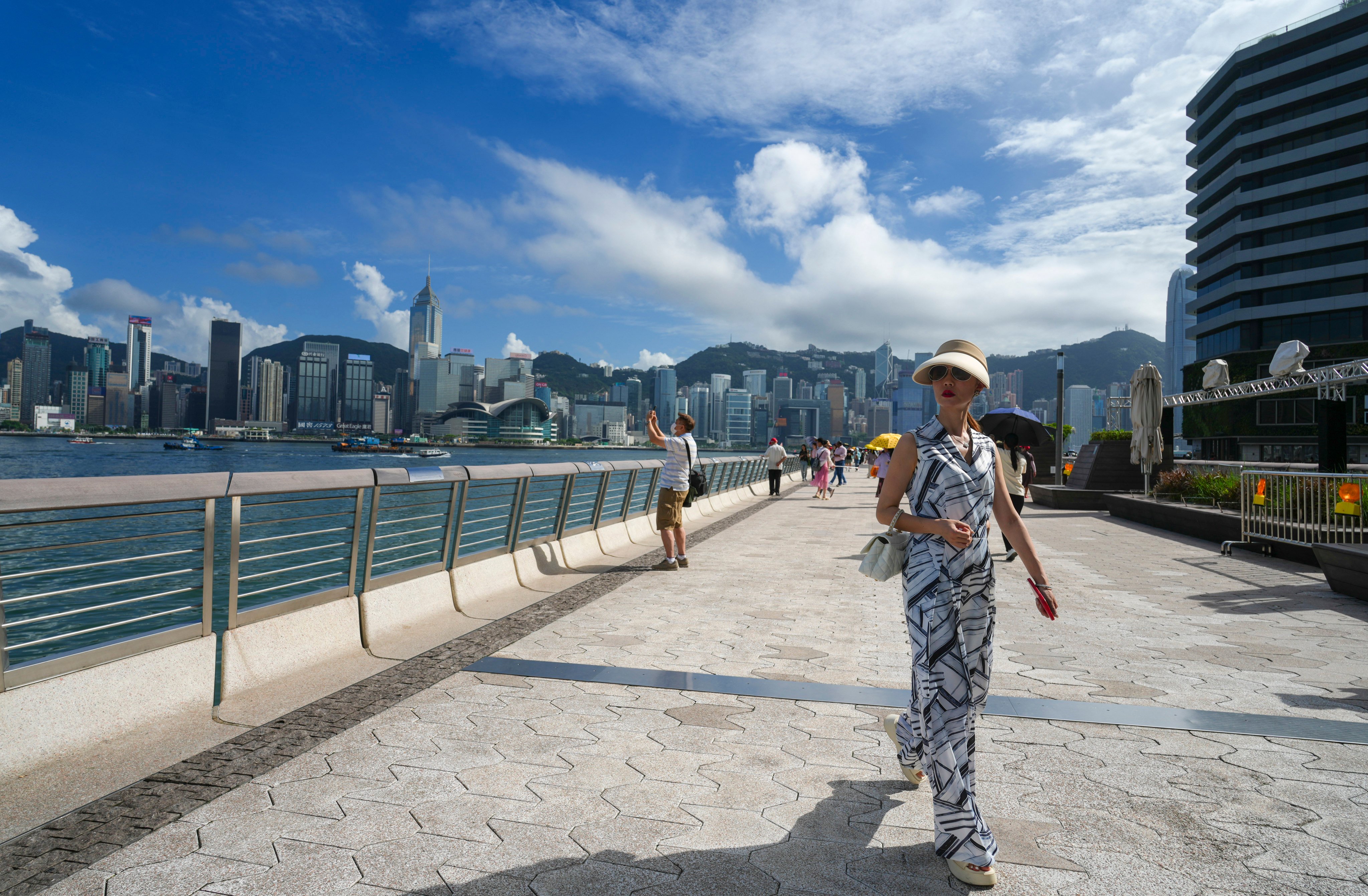 People visit the waterfront of Victoria Harbour in Tsim Sha Tsui on July 4. Hong Kong’s shopping discounts are no longer as tantalising and the city has few new and emerging tourist attractions. Photo: Sam Tsang