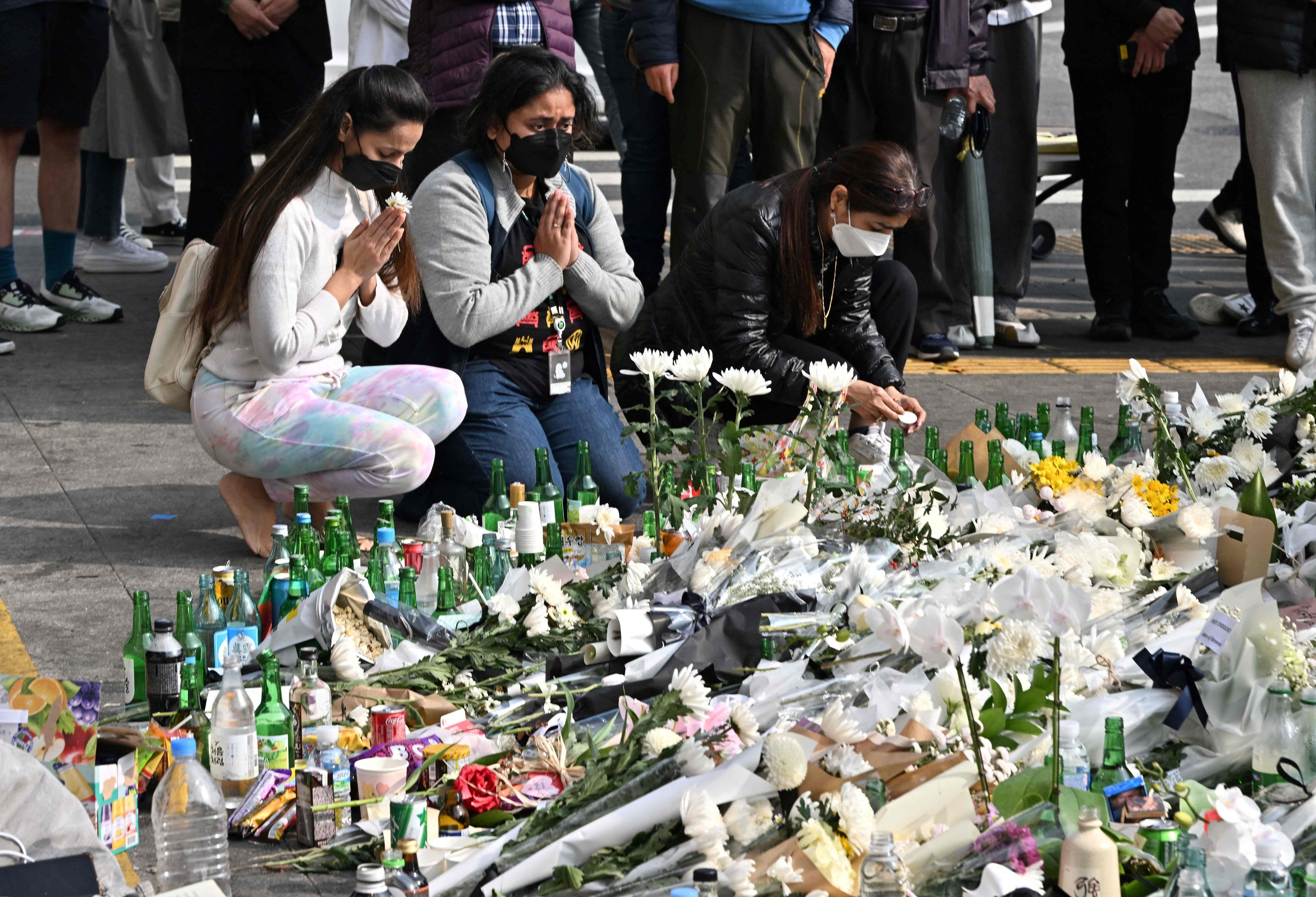 Mourners paying tribute at a makeshift memorial for the victims of the deadly Halloween crowd surge in October last year. Photo: AFP